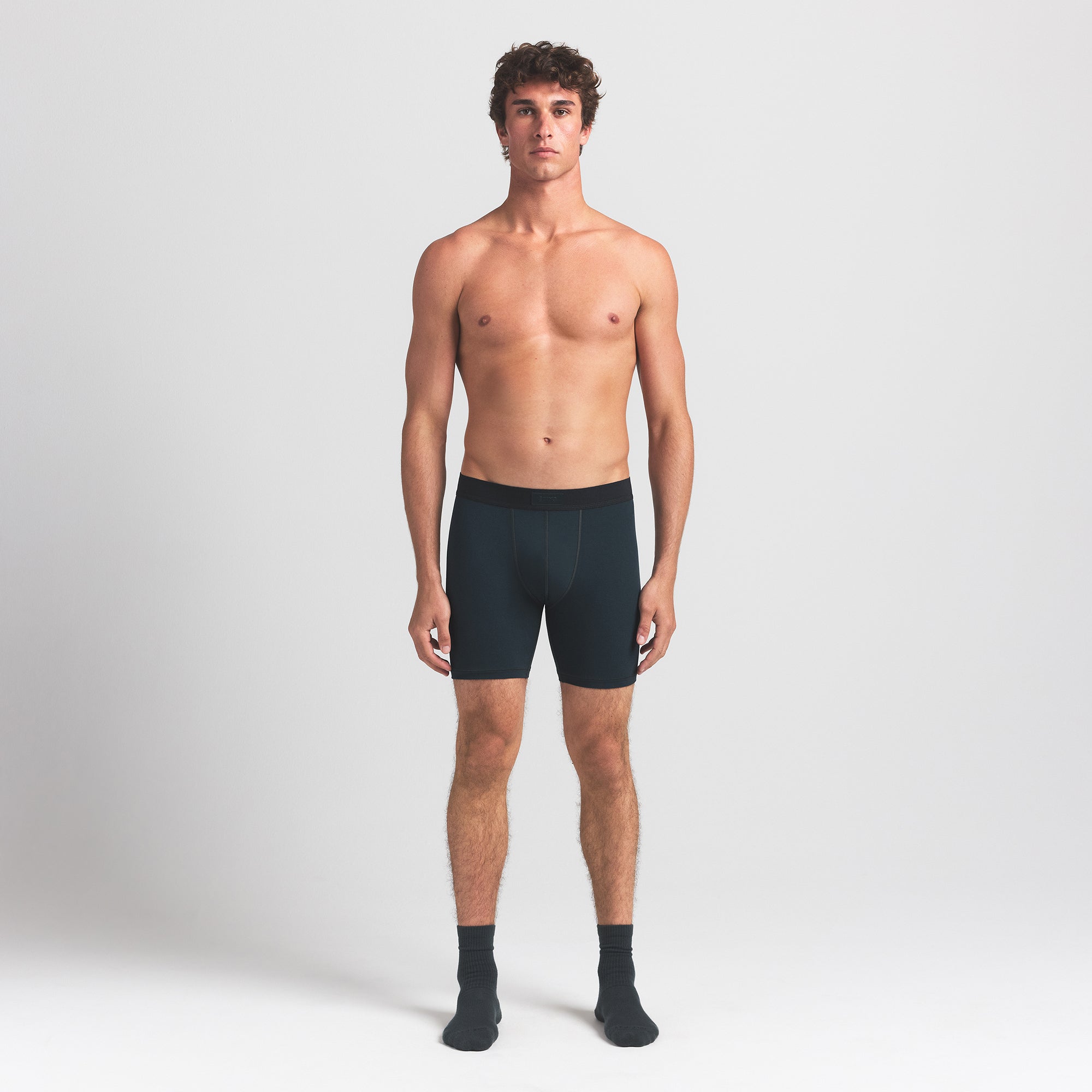 SKIMS COTTON MENS 5" BOXER BRIEF | VERDANT ON A MODEL FRONT VIEW @ | FOCUS: 0.0, 1.0, 0.9