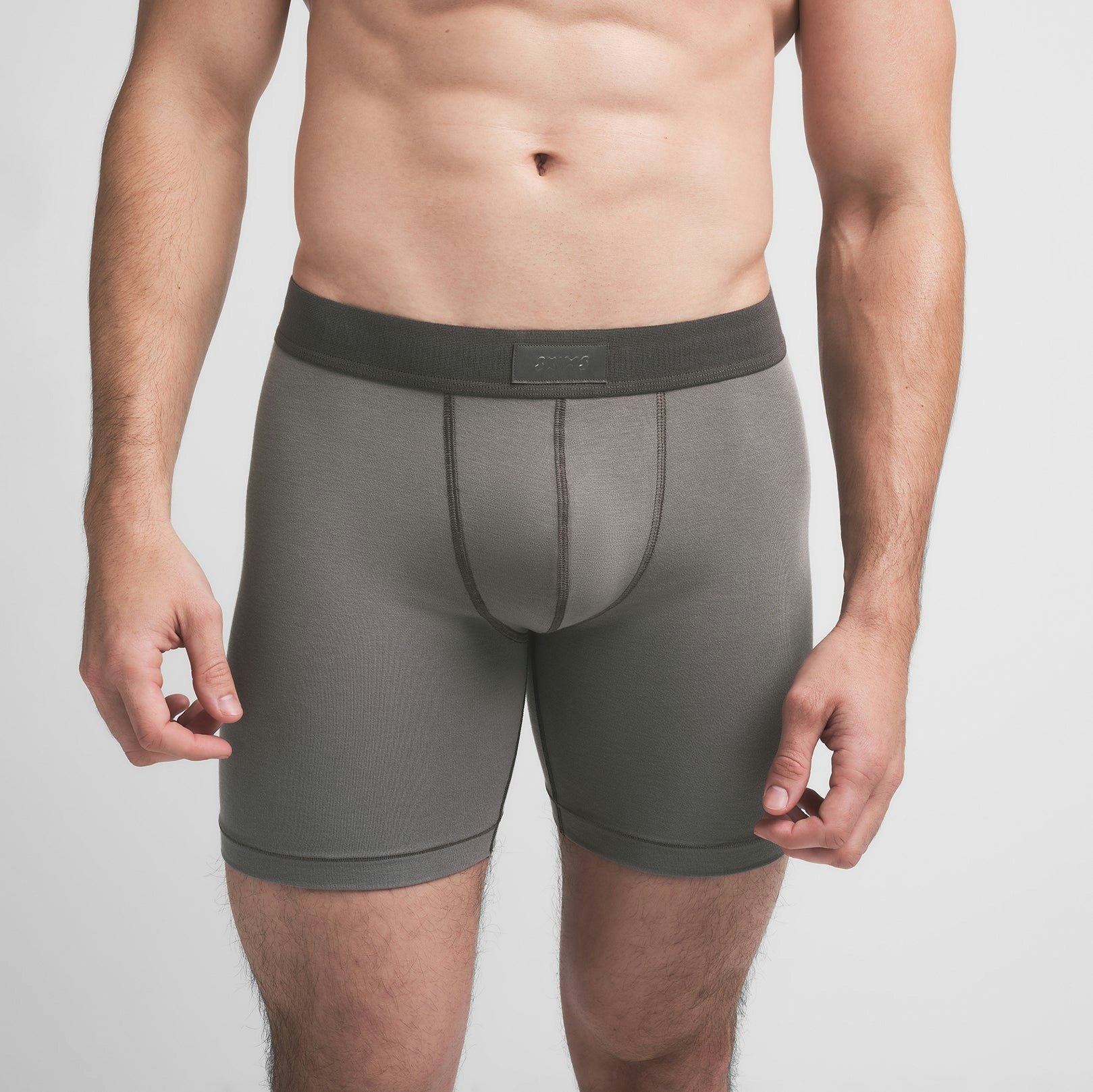 SKIMS COTTON MENS 5" BOXER BRIEF | WASHED GUNMETAL ON A MODEL FRONT VIEW @ | FOCUS: 0.9, 0.1, 0.7