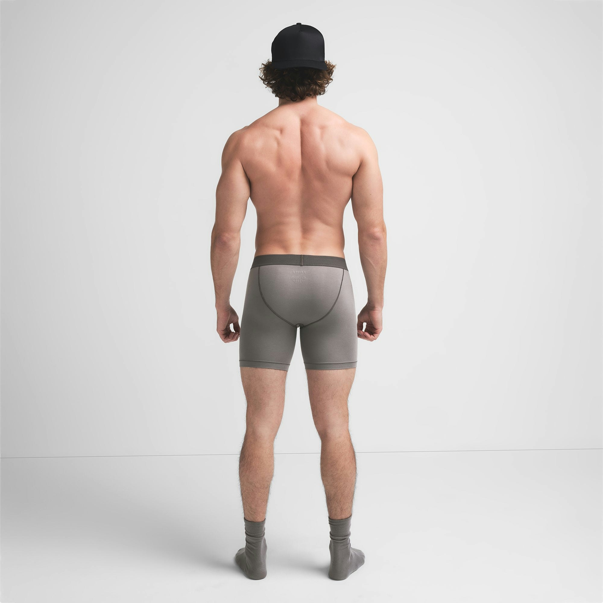 SKIMS COTTON MENS 5" BOXER BRIEF | WASHED GUNMETAL ON A MODEL BACK VIEW @ | FOCUS: 0.9, 0.1, 0.7