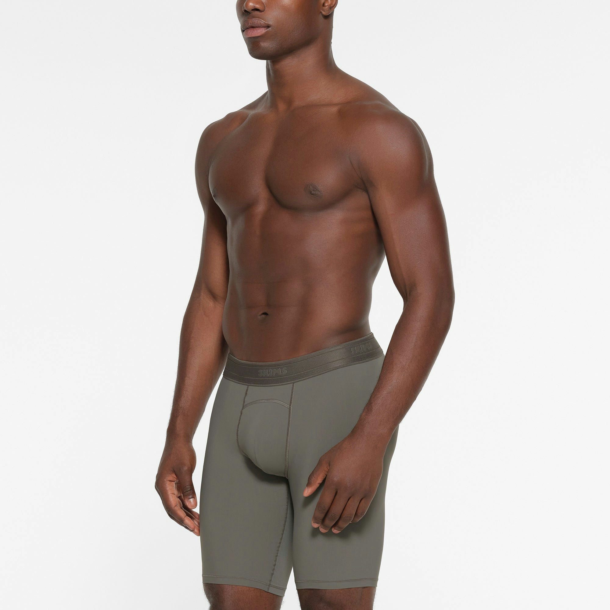 SKIMS SPORT MENS 9" BOXER BRIEF | GUNMETAL ON A MODEL SIDE VIEW