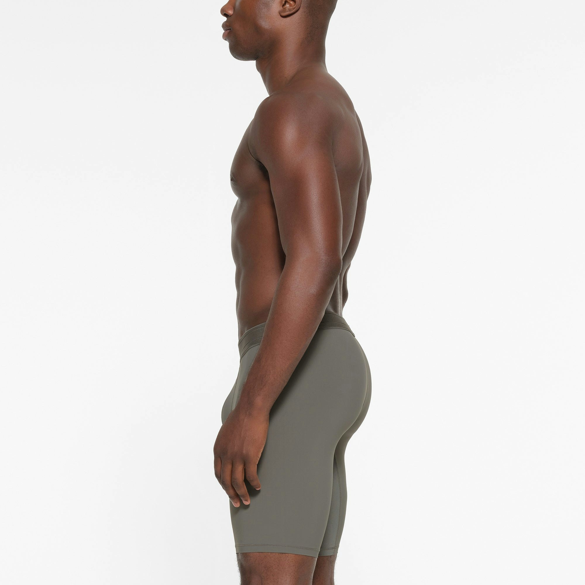 SKIMS SPORT MENS 9" BOXER BRIEF | GUNMETAL ON A MODEL SIDE VIEW