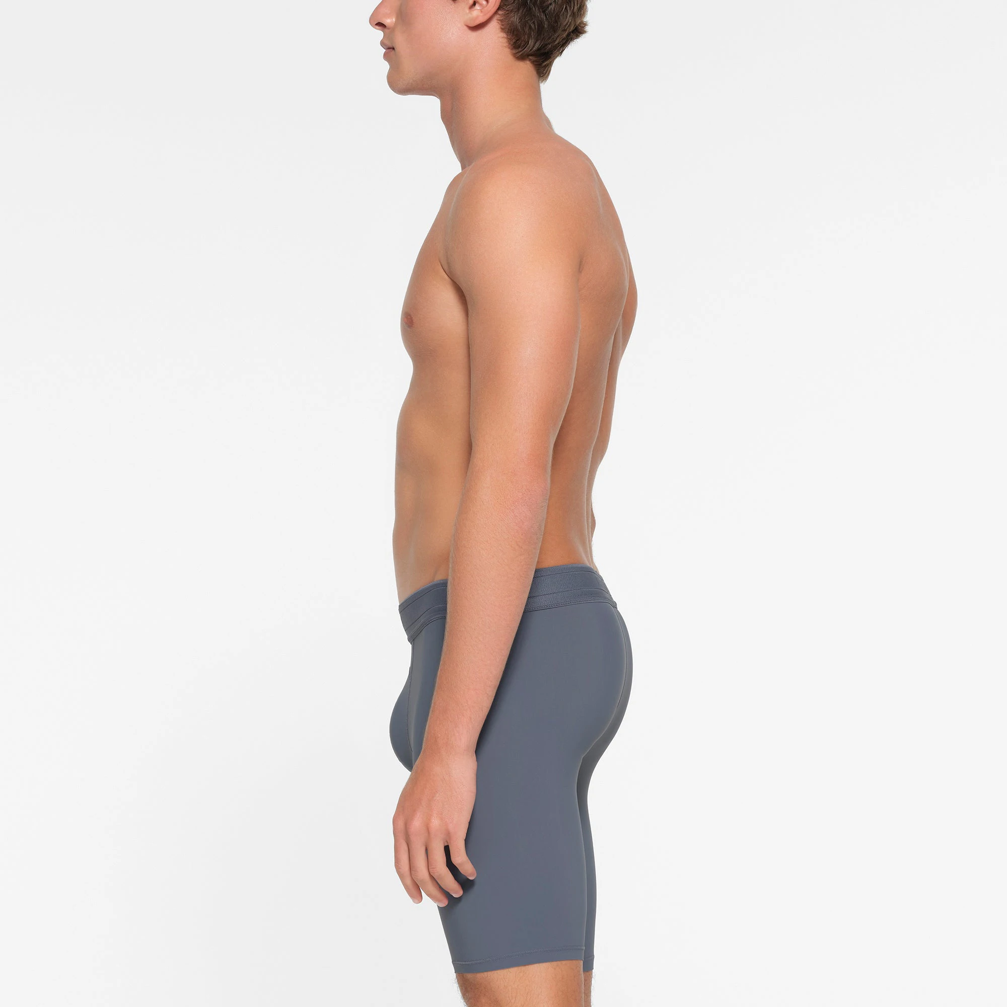 SKIMS SPORT MENS 9" BOXER BRIEF | STEEL BLUE ON A MODEL SIDE VIEW