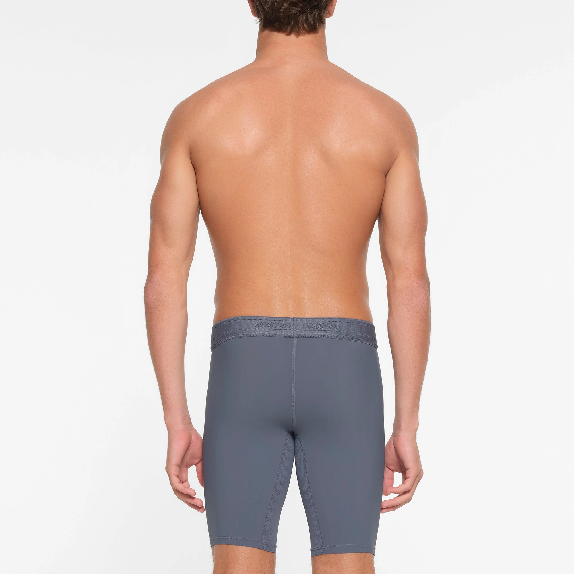 SKIMS SPORT MENS 9" BOXER BRIEF | STEEL BLUE ON A MODEL BACK VIEW