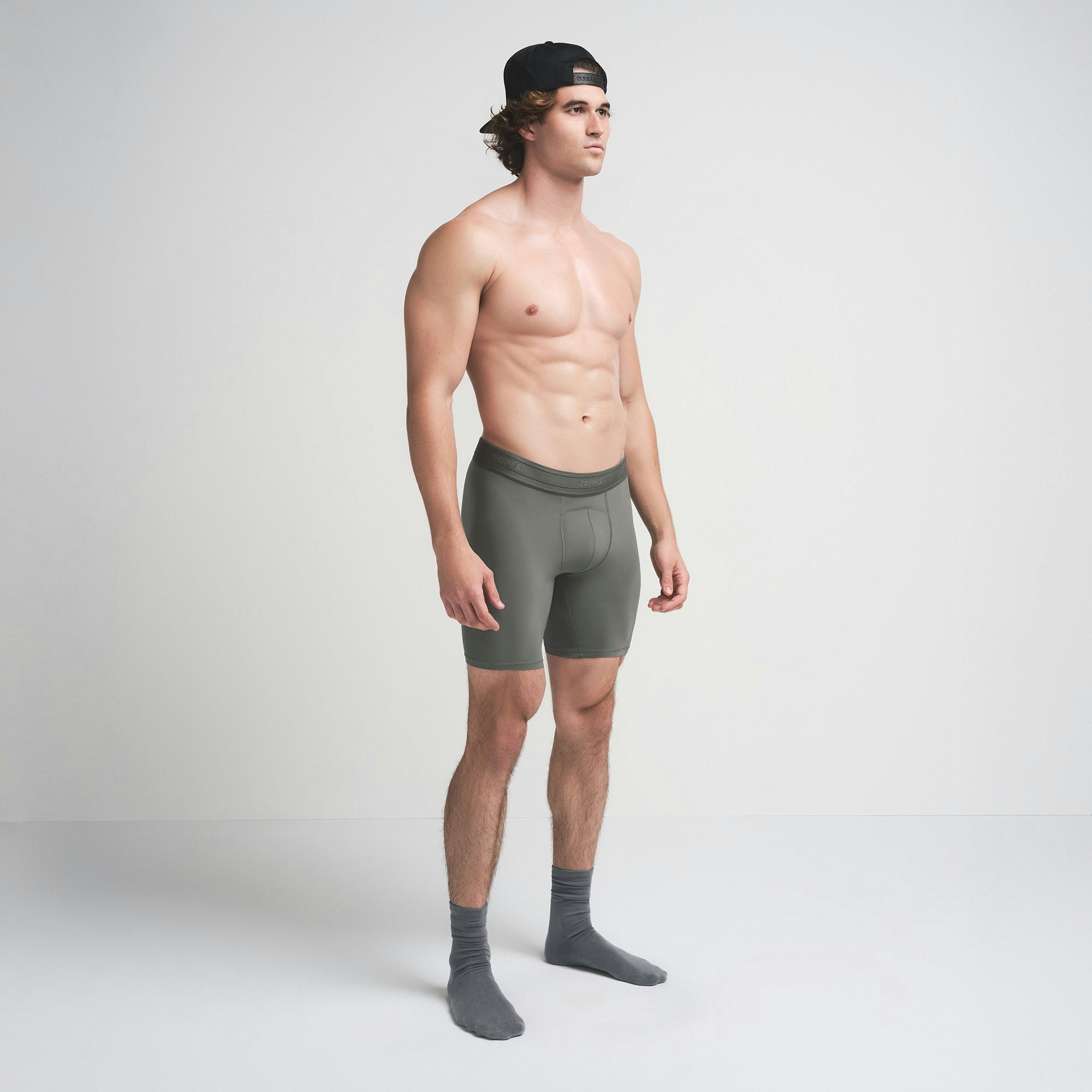 SKIMS SPORT MENS 7" BOXER BRIEF | GUNMETAL ON A MODEL SIDE VIEW | FOCUS: 0.0, 1.0, 0.9