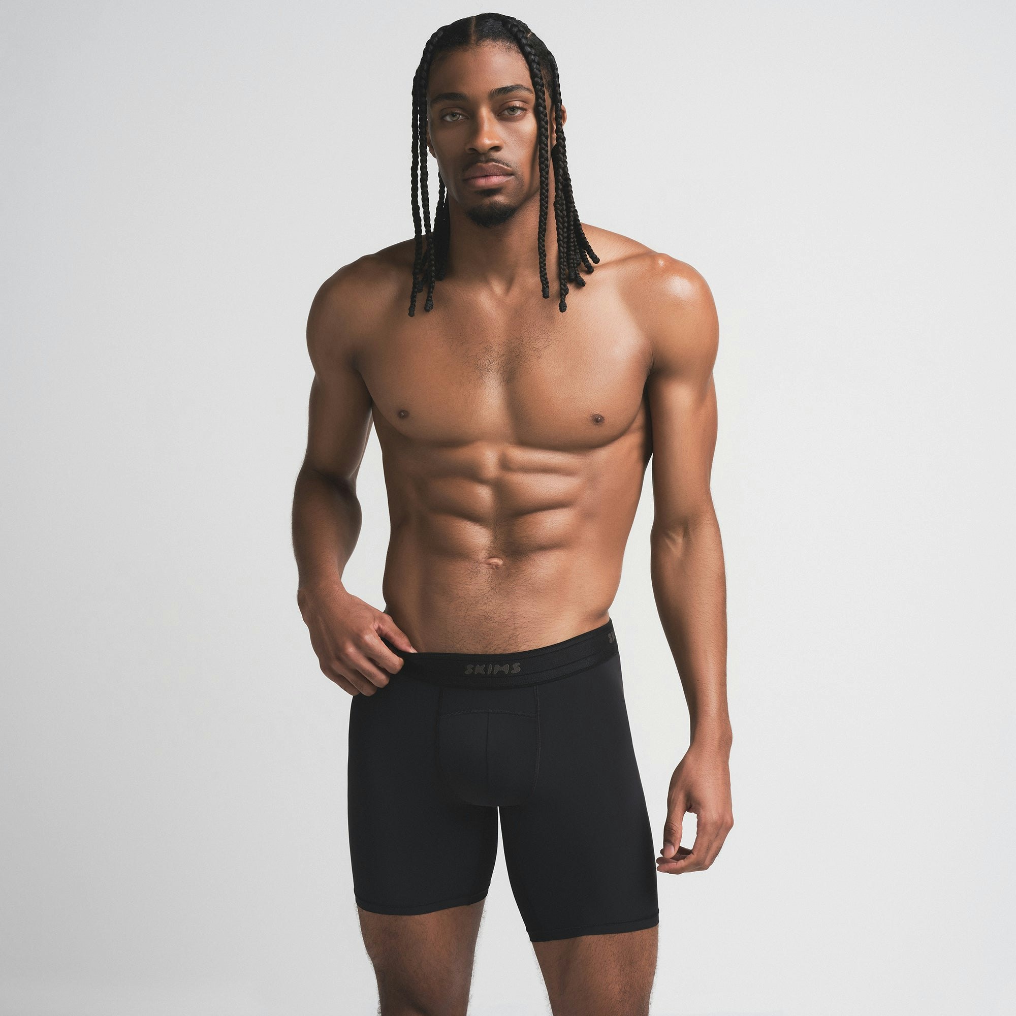 SKIMS SPORT MENS 7" BOXER BRIEF | OBSIDIAN ON A MODEL SIDE VIEW | FOCUS: 0.0, 1.0, 0.9