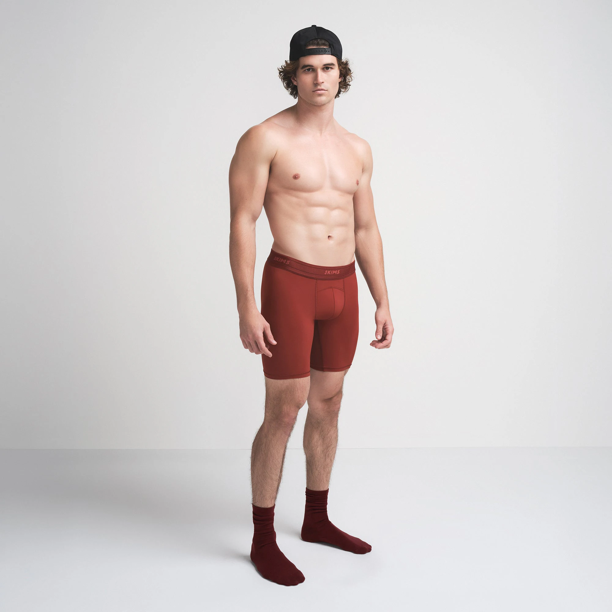 SKIMS SPORT MENS 7 INCH BOXER BRIEF | SANGRIA ON A MODEL SIDE VIEW | FOCUS: 0.0, 1.0, 0.9