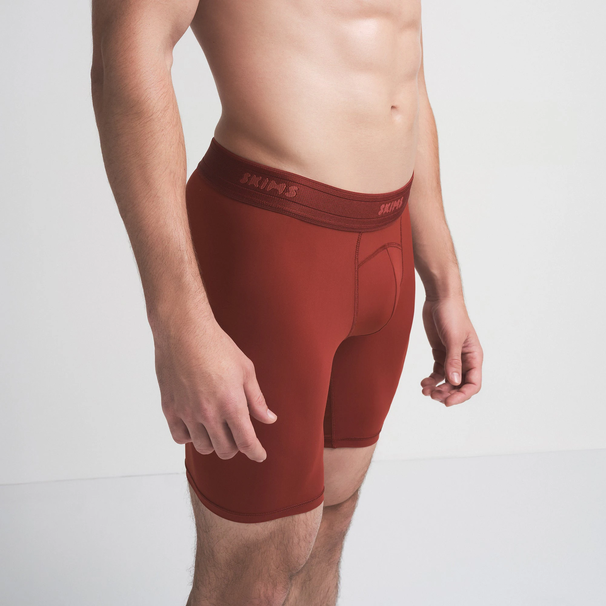 SKIMS SPORT MENS 7 INCH BOXER BRIEF | SANGRIA ON A MODEL SIDE VIEW | FOCUS: 0.0, 1.0, 0.9