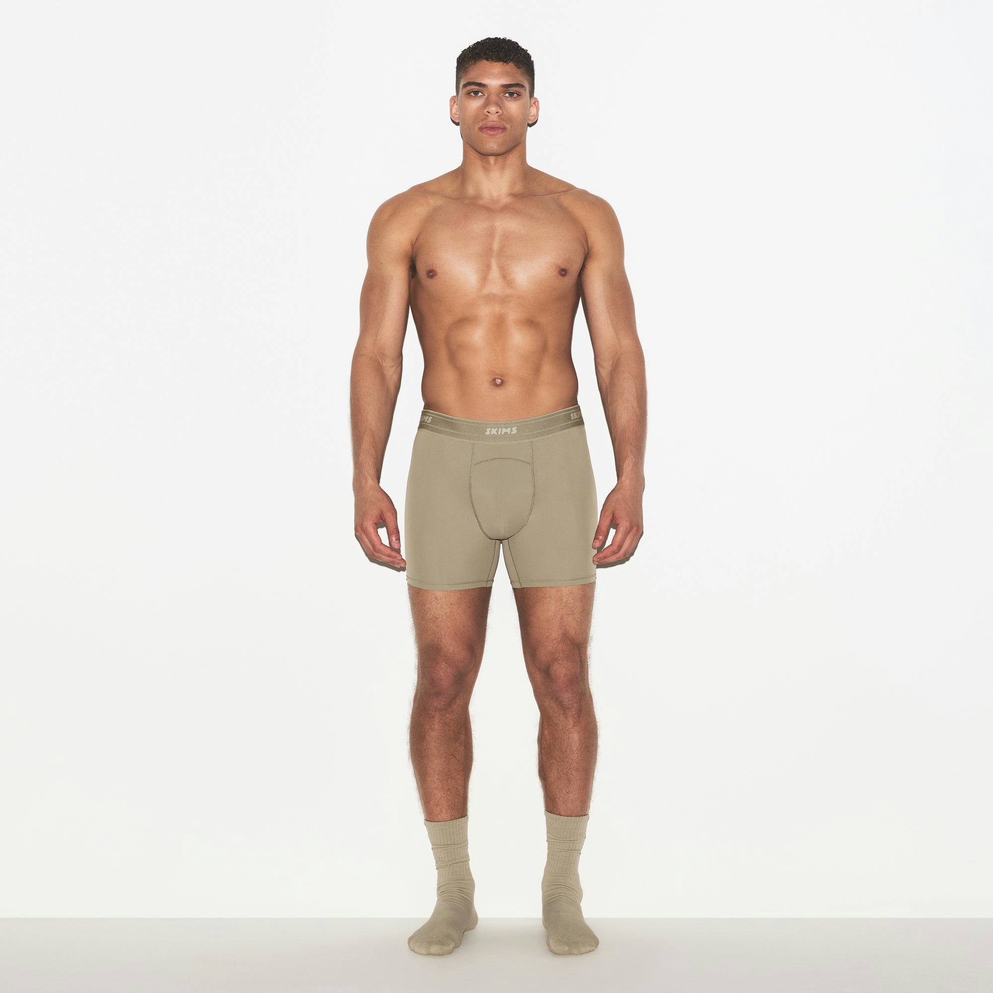SKIMS SPORT MENS 5" BOXER BRIEF | DUNE ON A MODEL FRONT VIEW | FOCUS: 0.0, 1.0, 0.9