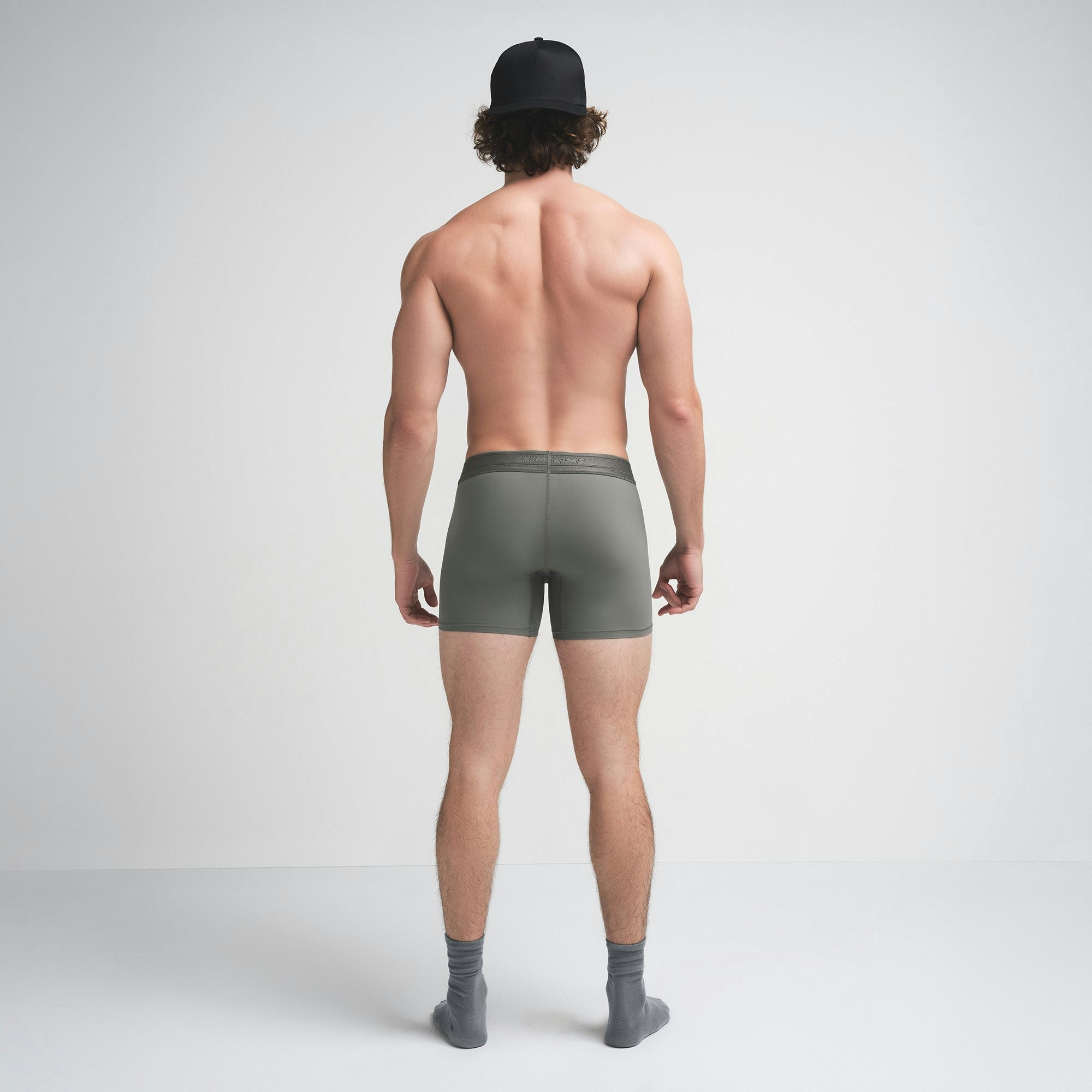 SKIMS SPORT MENS 5" BOXER BRIEF | GUNMETAL ON A MODEL SIDE VIEW | FOCUS: 0.0, 1.0, 0.9