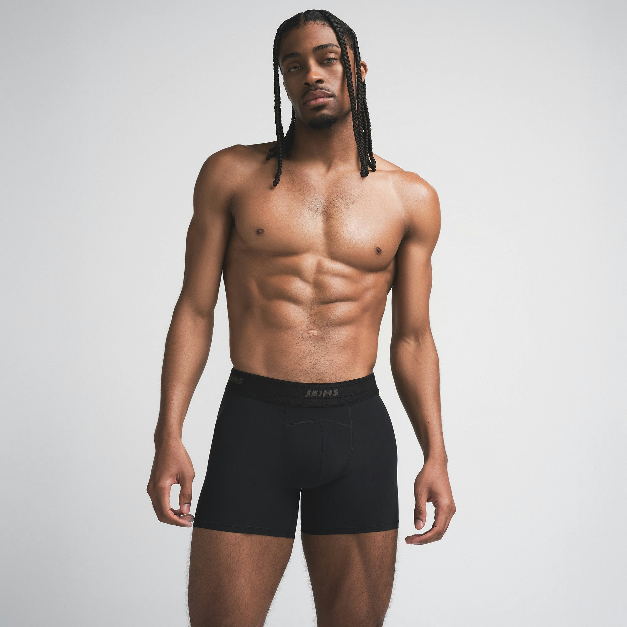 SKIMS SPORT MENS 5" BOXER BRIEF | OBSIDIAN ON A MODEL SIDE VIEW | FOCUS: 0.0, 1.0, 0.9