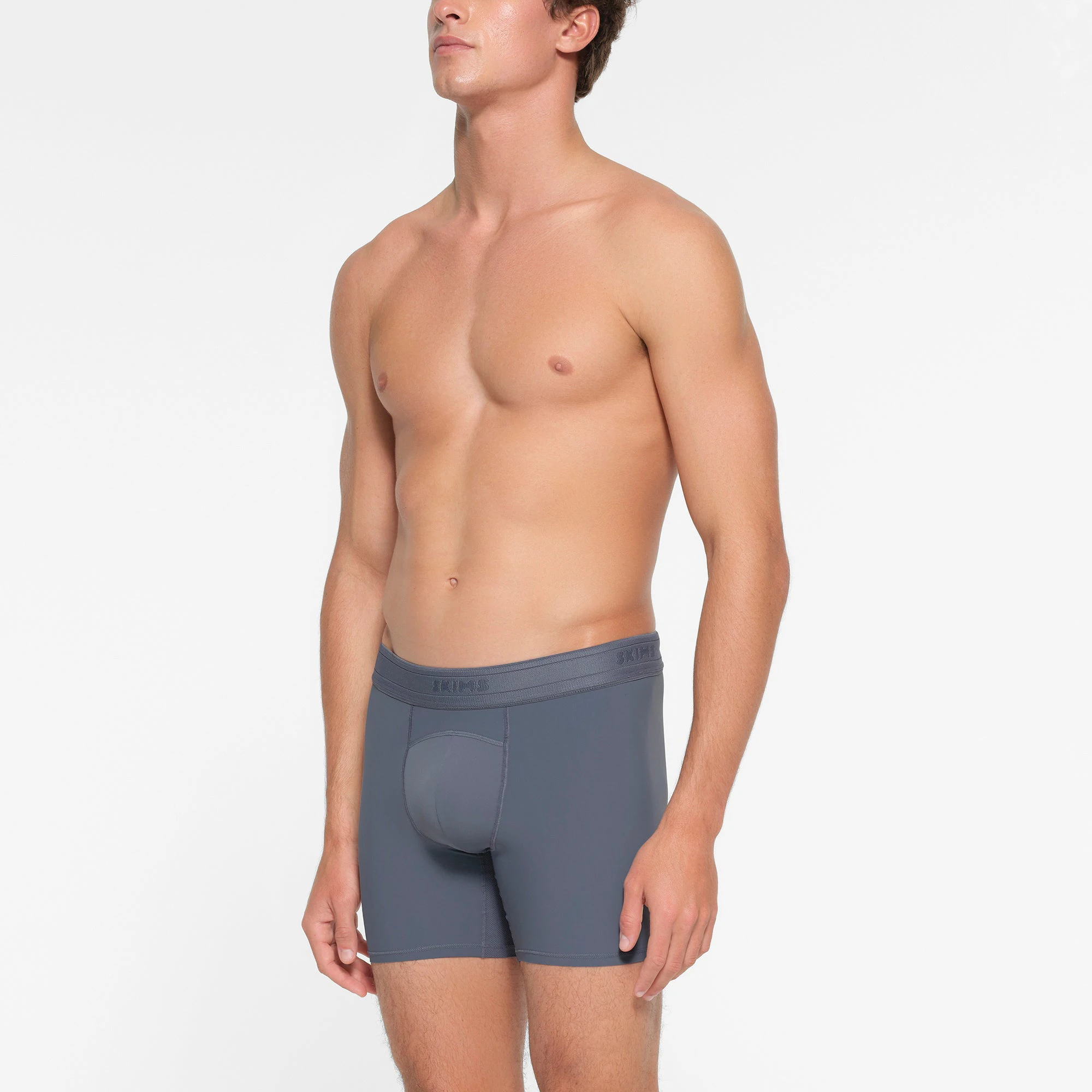 SKIMS SPORT MENS 5" BOXER BRIEF | STEEL BLUE  ON A MODEL SIDE VIEW
