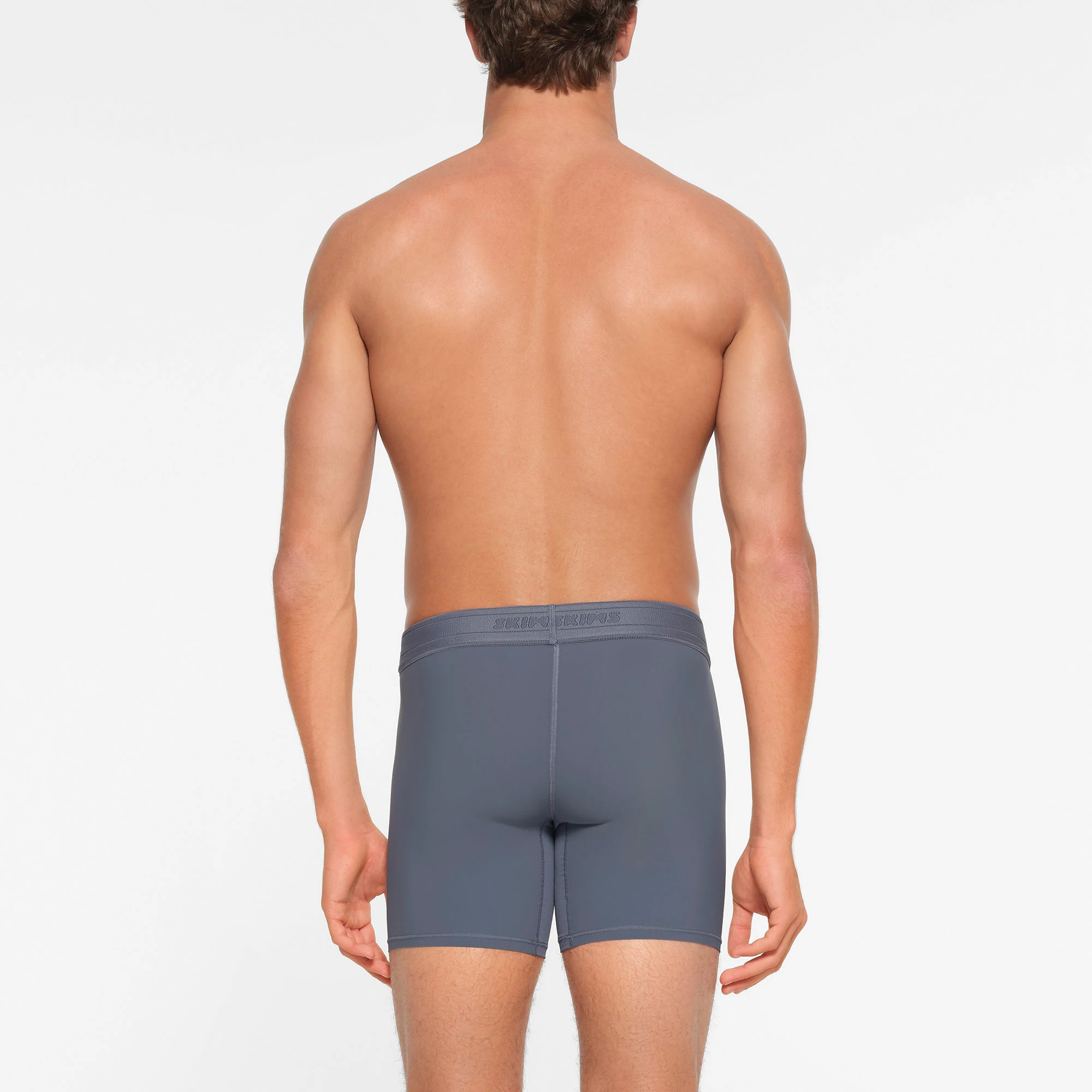 SKIMS SPORT MENS 5" BOXER BRIEF | STEEL BLUE  ON A MODEL BACK VIEW