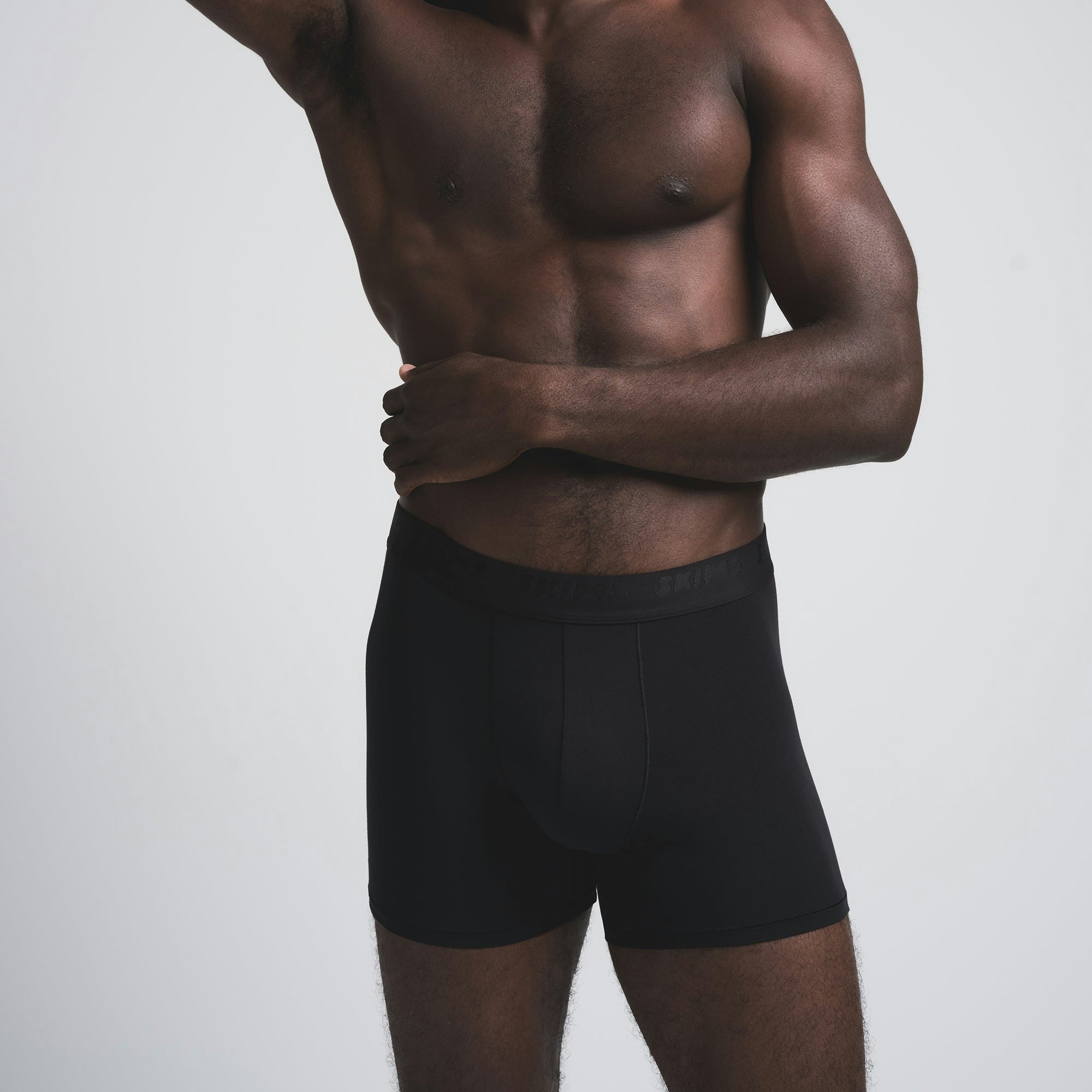 SKIMS STRETCH MENS 3 INCH BOXER BRIEF 3-PACK | BRICK MULTI ON A MODEL SIDE VIEW