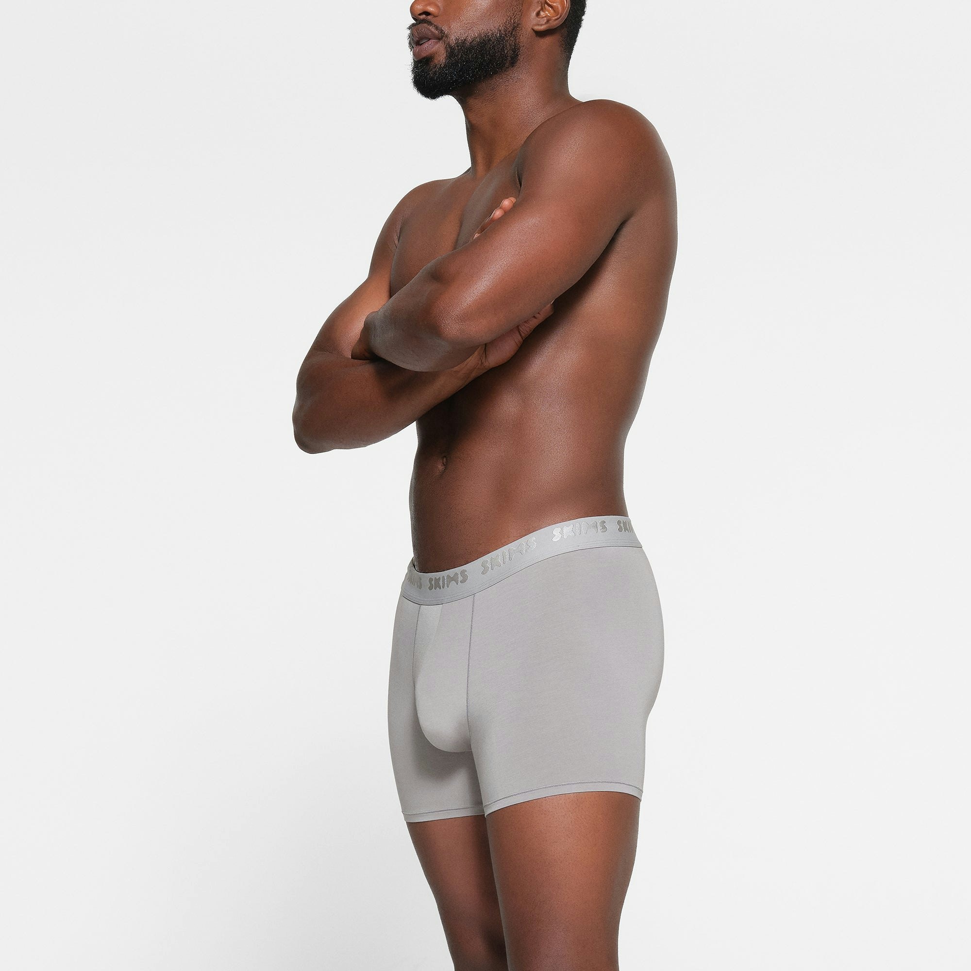 SKIMS STRETCH MENS 3" BOXER BRIEF 3-PACK WORN BY A MODEL IN SIDE VIEW