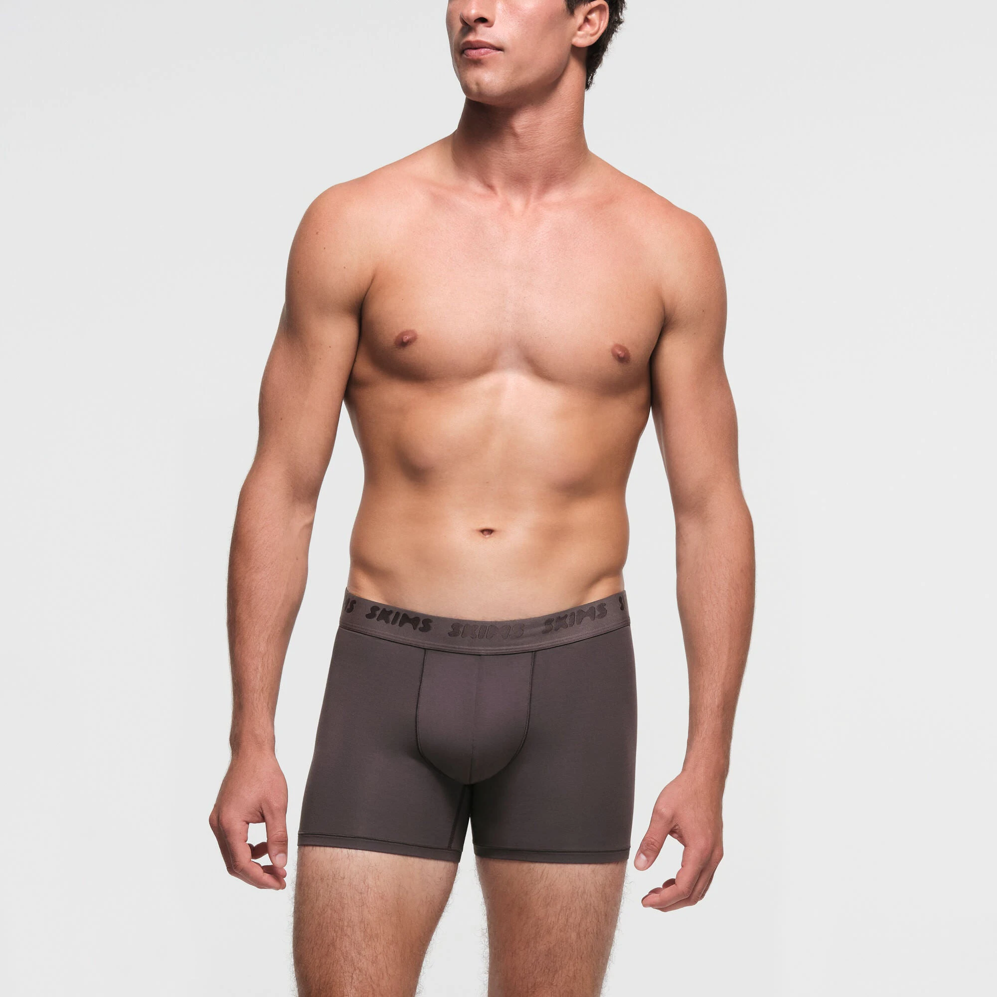 SKIMS STRETCH MENS 3" BOXER BRIEF 3-PACK | RUST MULTI ON A MODEL FRONT VIEW