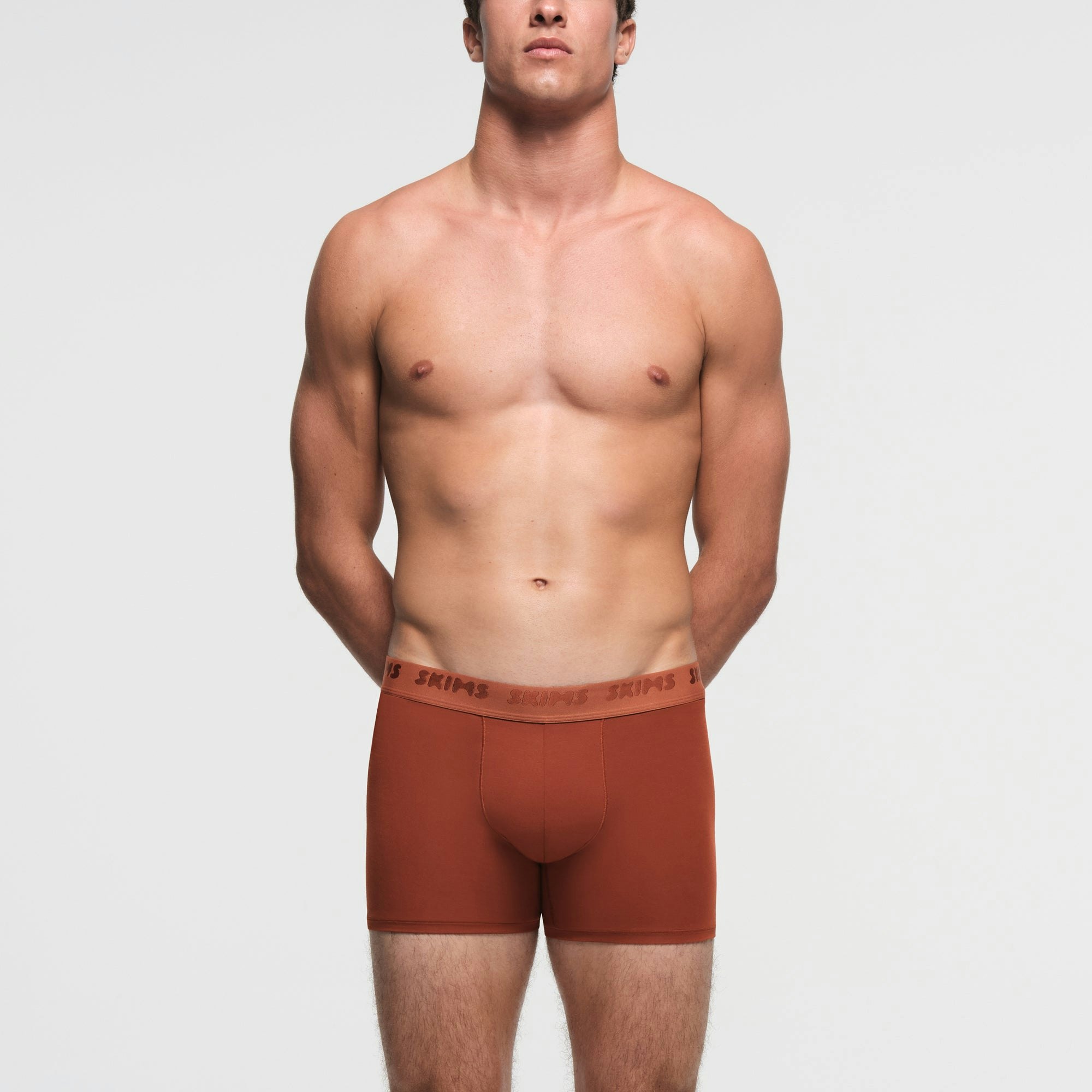 SKIMS STRETCH MENS 3" BOXER BRIEF | RUST ON A MODEL FRONT VIEW
