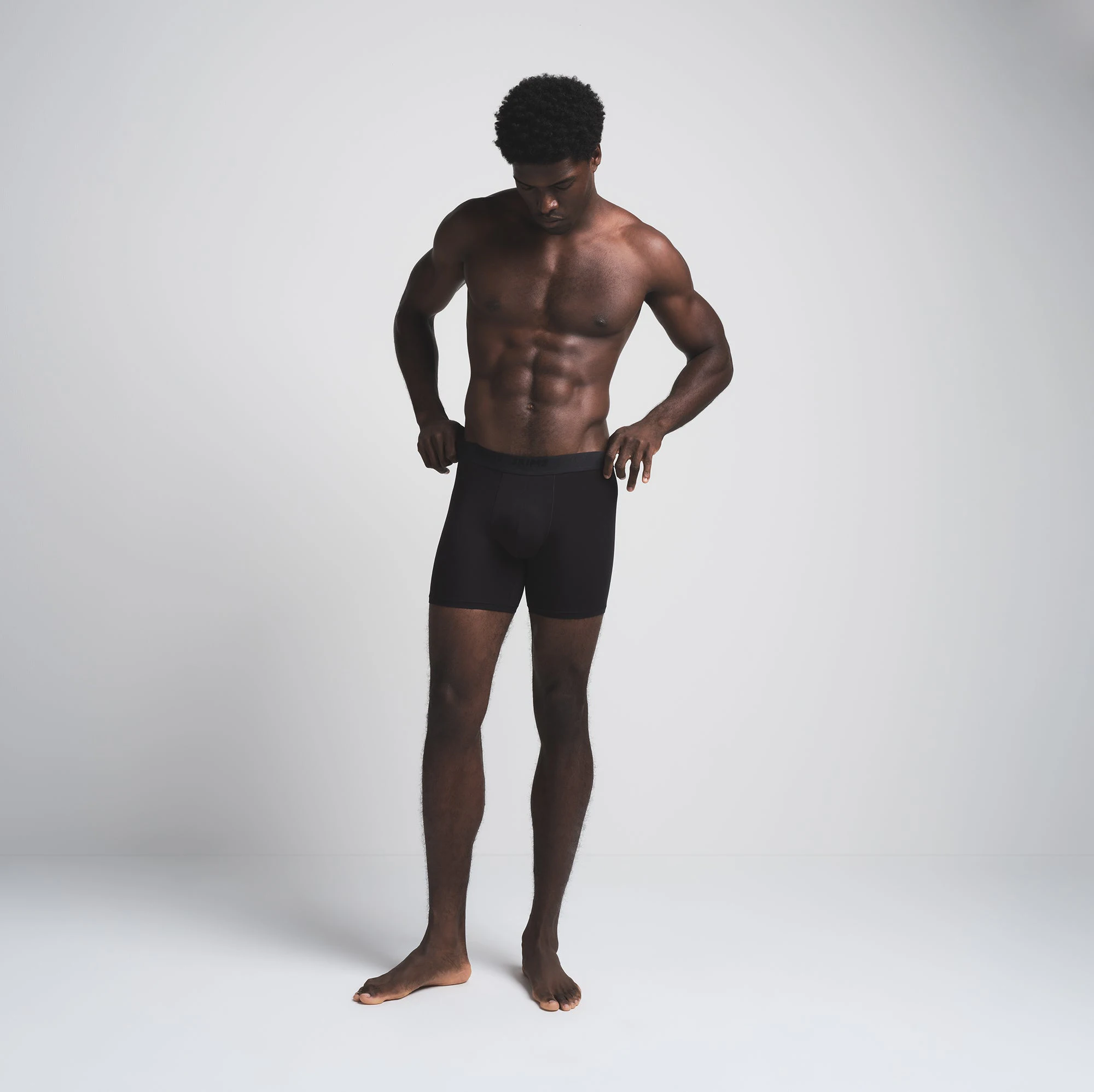 SKIMS STRETCH MENS 5 INCH BOXER BRIEF 3-PACK | BRICK MULTI ON A MODEL FRONT VIEW