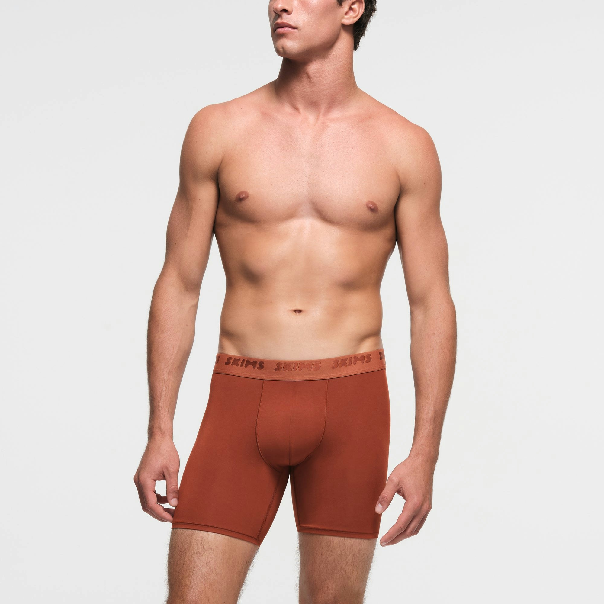 SKIMS STRETCH MENS 5" BOXER BRIEF | RUST ON A MODEL FRONT VIEW
