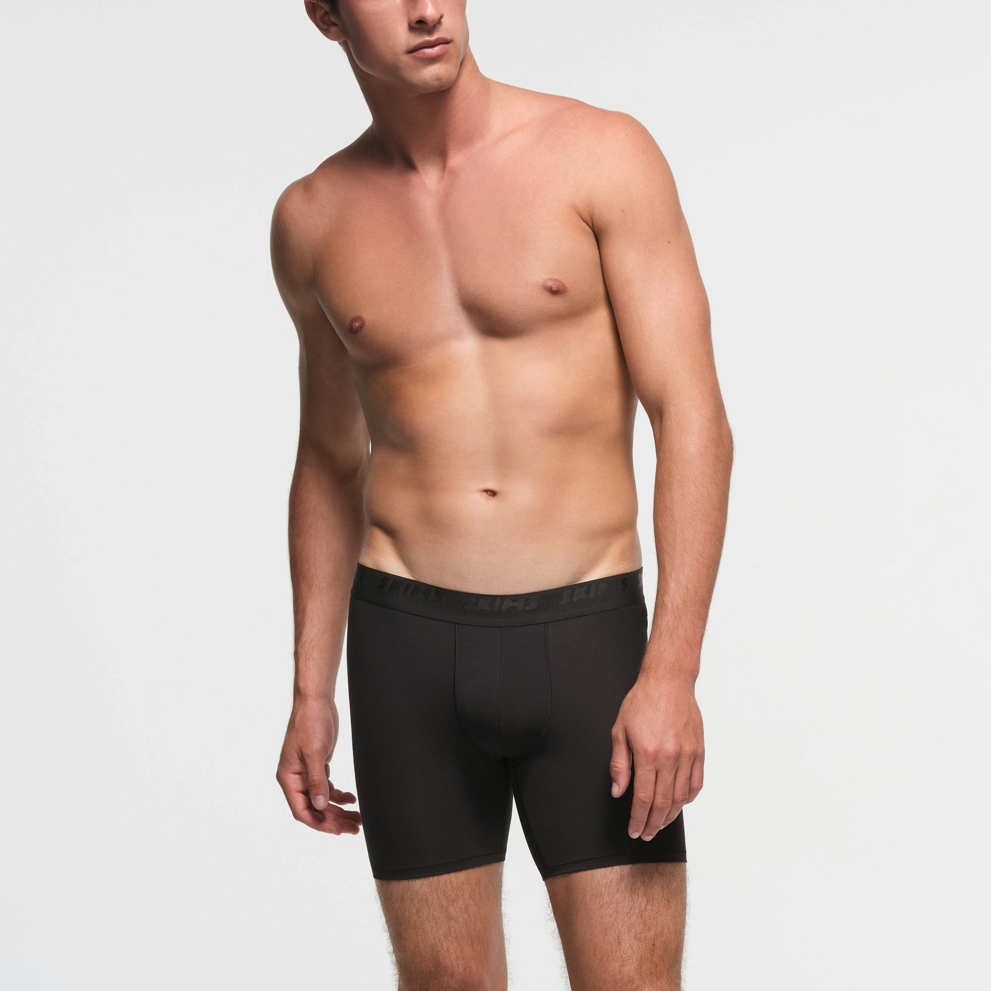 SKIMS STRETCH MENS 5" BOXER BRIEF 3-PACK | RUST MULTI ON A MODEL FRONT VIEW