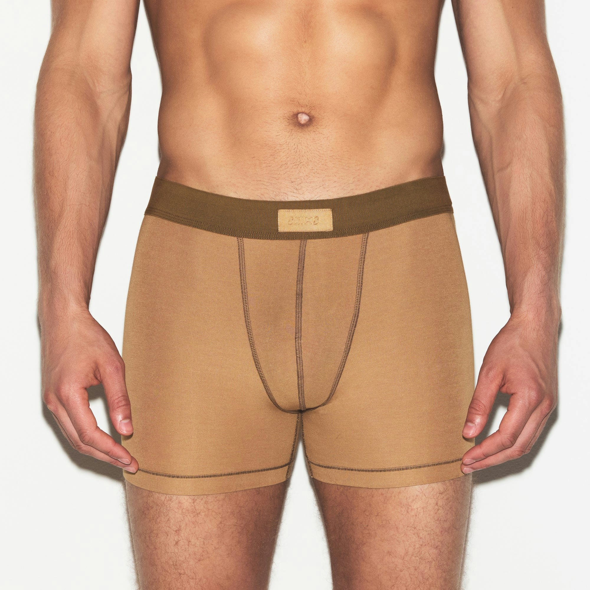 SKIMS COTTON MENS 3 INCH BOXER BRIEF 3-PACK | RUSSET MULTI ON A MODEL SIDE VIEW | FOCUS: 0.0, 1.0, 0.9