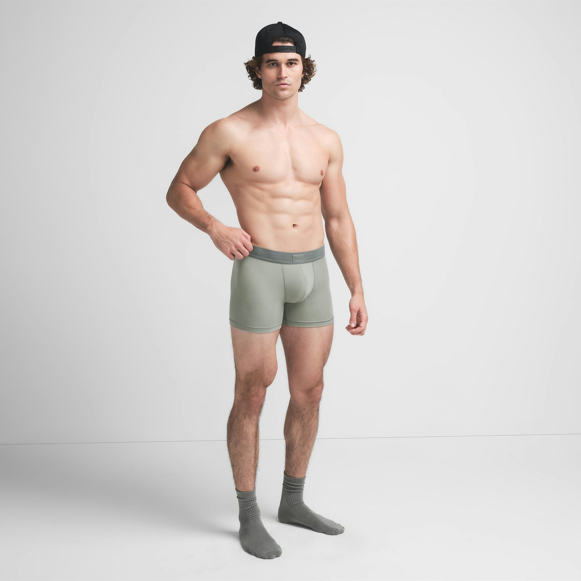 SKIMS COTTON MENS 3" BOXER BRIEF 3-PACK | STONE MULTI ON A MODEL SIDE VIEW @ | FOCUS: 0.9, 0.1, 0.7