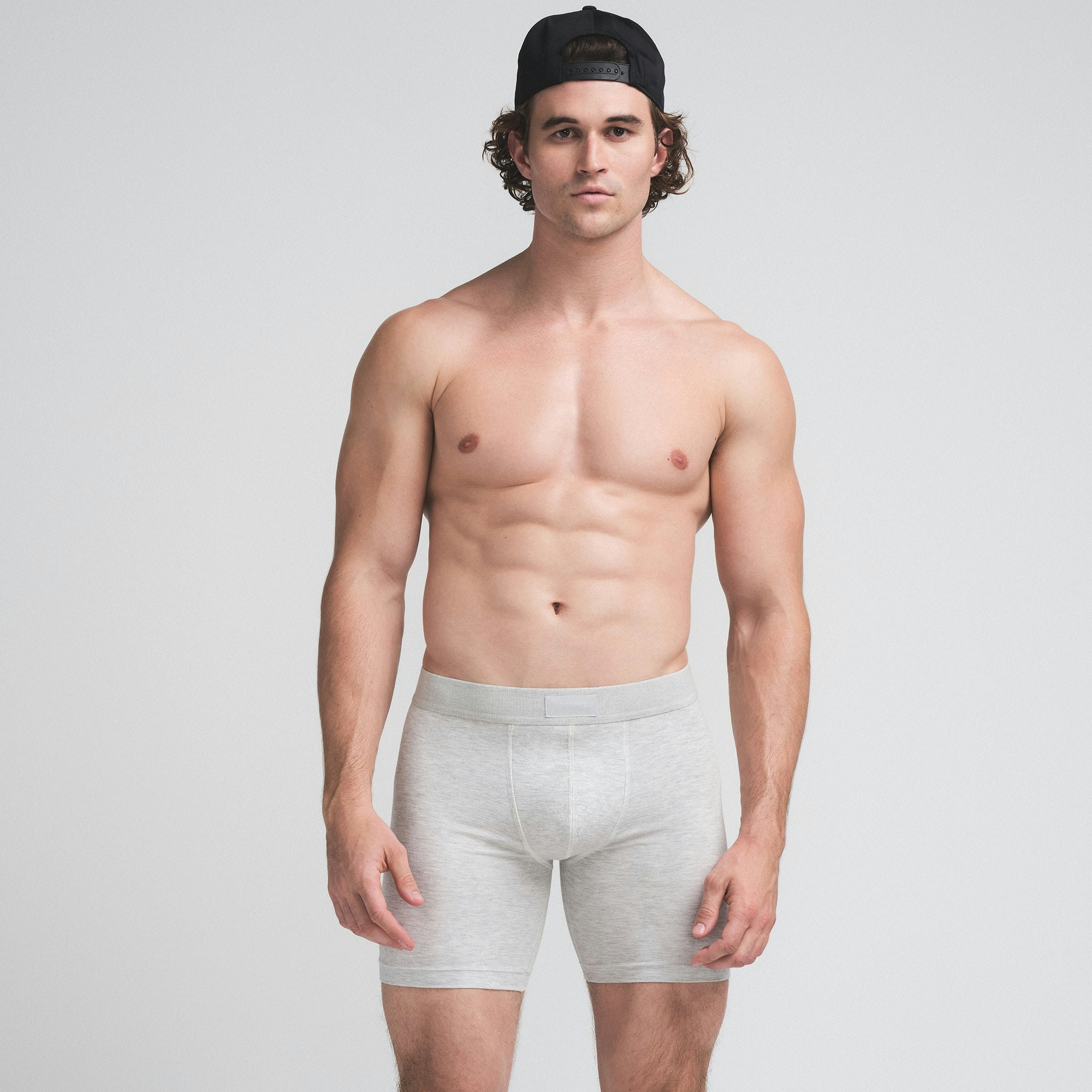 SKIMS COTTON MENS 5" BOXER BRIEF 3-PACK | BUBBLEGUM UMBER MULTI ON A MODEL SIDE VIEW | FOCUS: 0.0, 1.0, 0.9