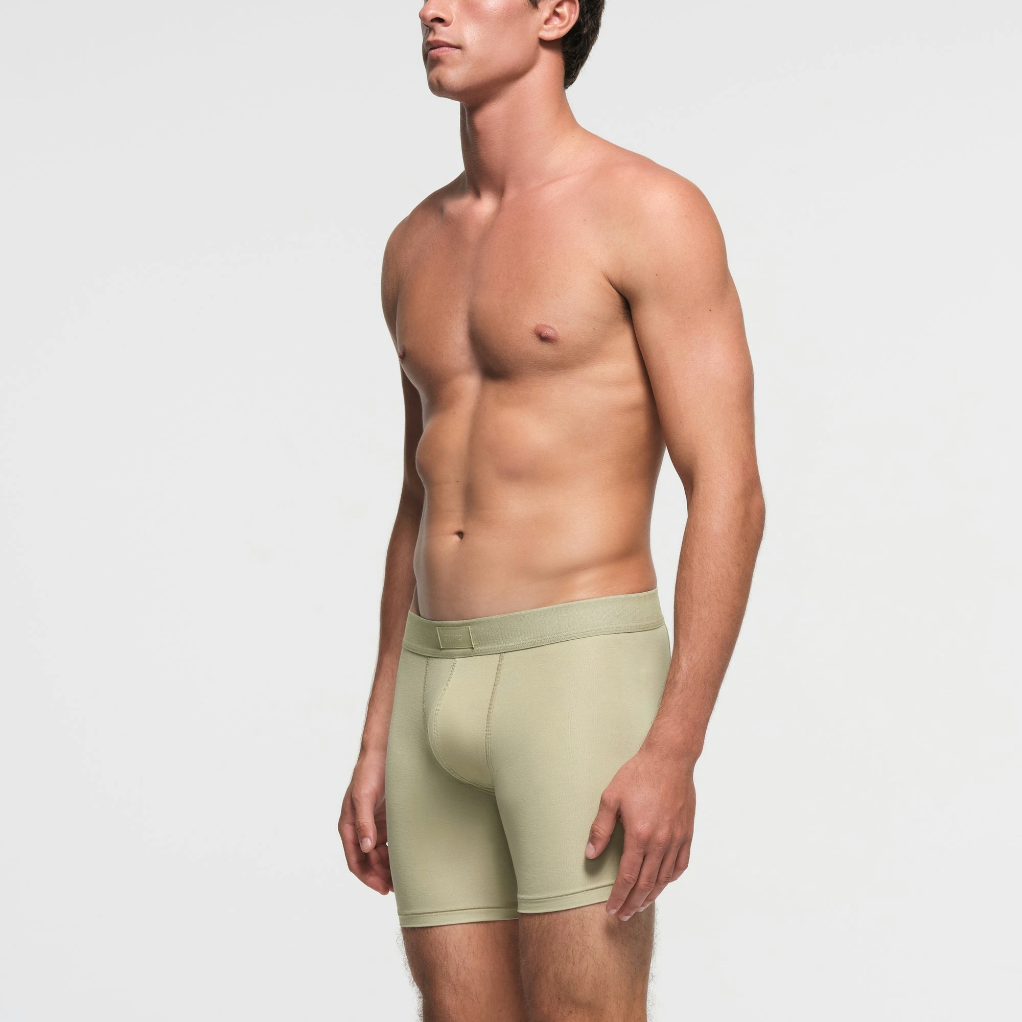 SKIMS COTTON MENS 5" BOXER BRIEF | PHOSPHORUS ON A MODEL SIDE VIEW