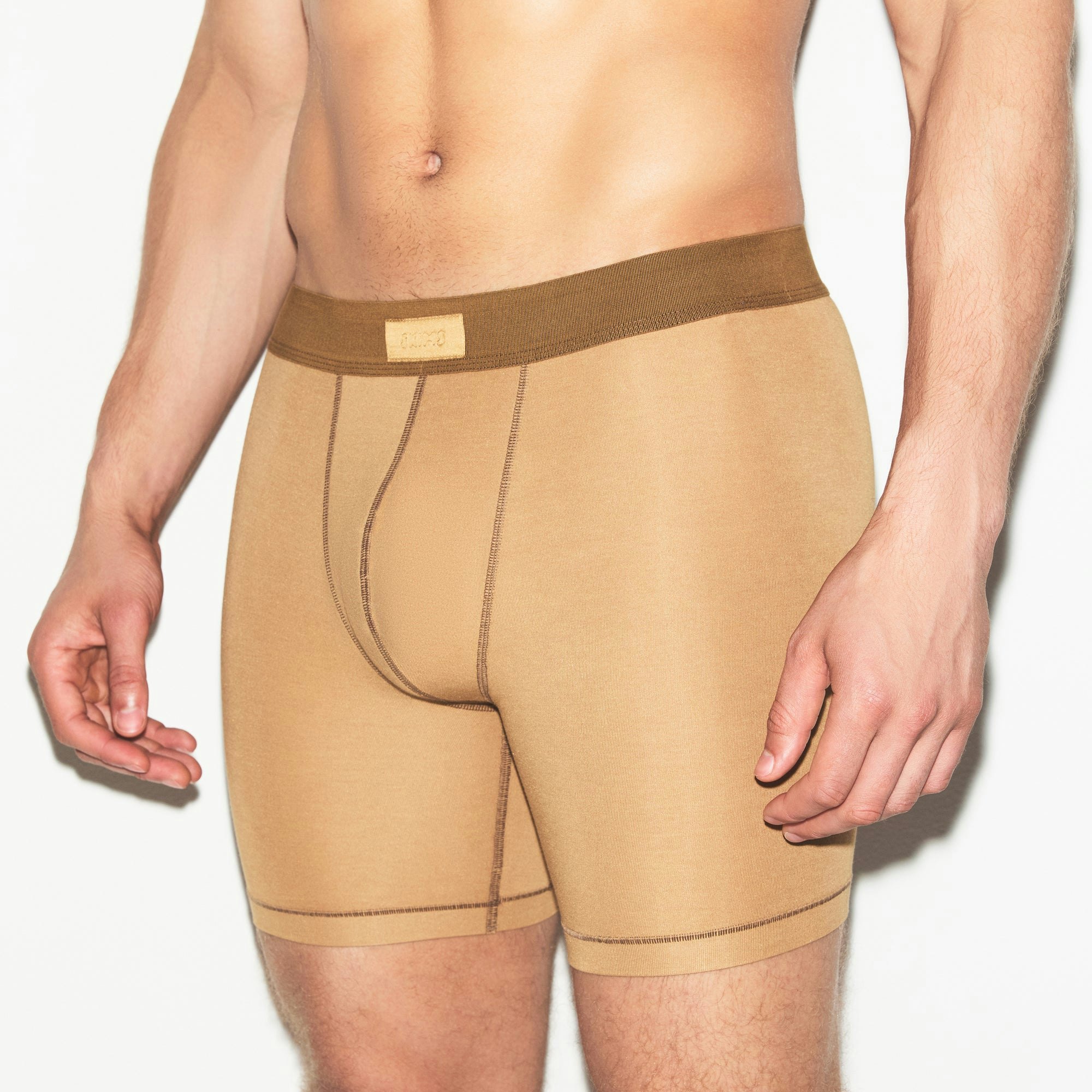 SKIMS COTTON MENS 5 INCH BOXER BRIEF 3-PACK | RUSSET MULTI ON A MODEL SIDE VIEW | FOCUS: 0.0, 1.0, 0.9