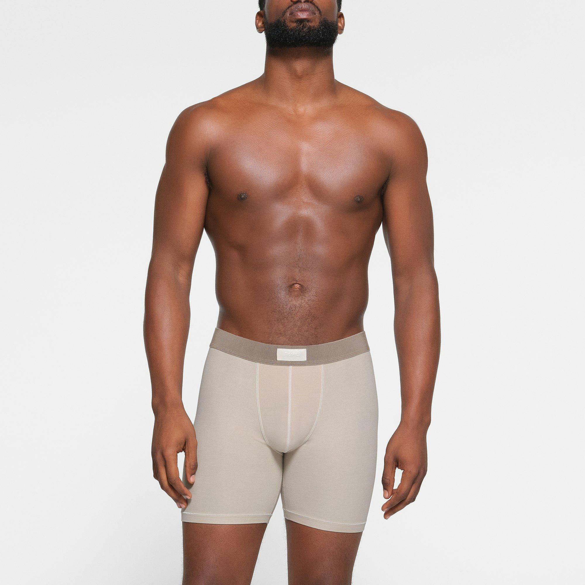 SKIMS COTTON MENS 5" BOXER BRIEF 3-PACK WORN BY A MODEL IN FRONT VIEW