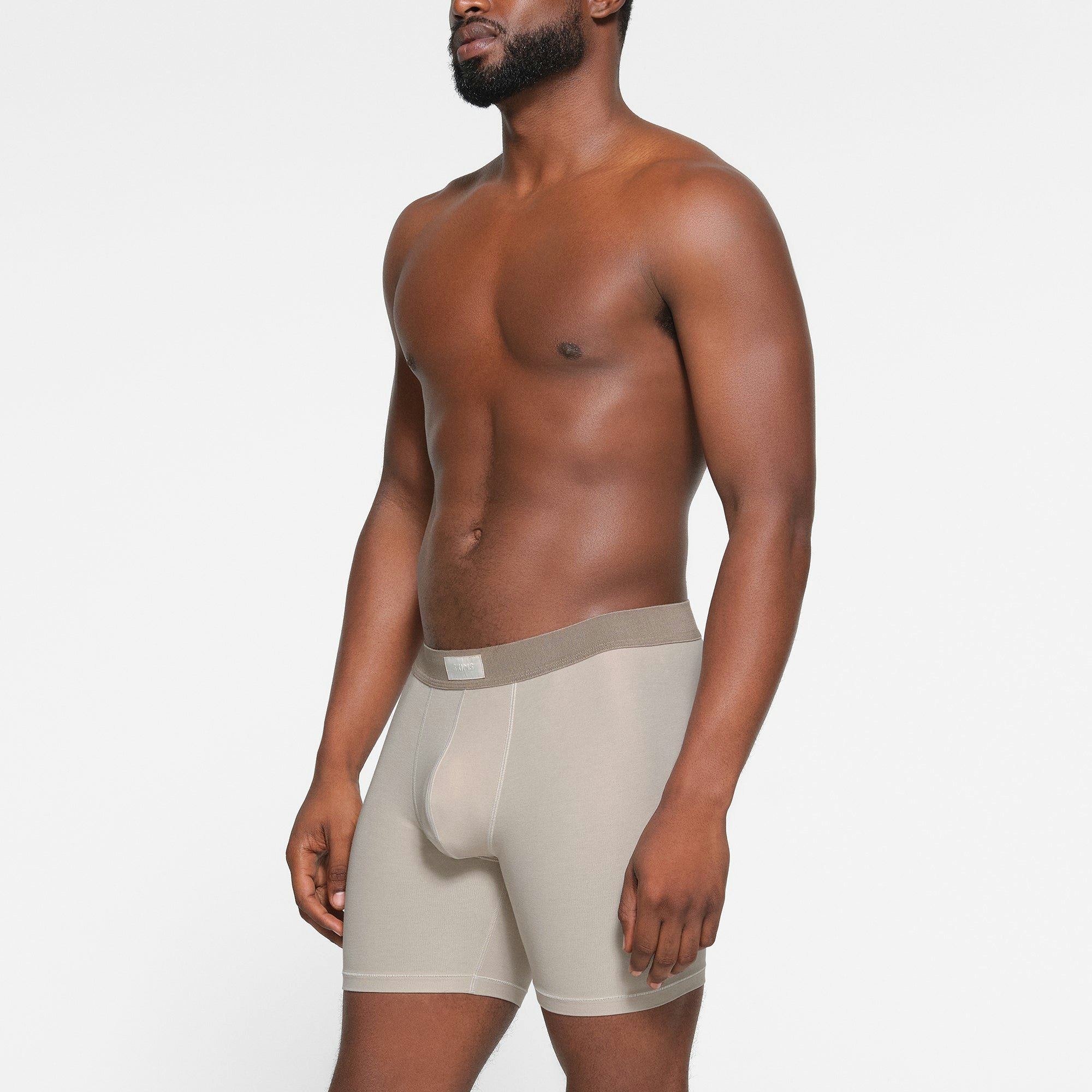 SKIMS COTTON MENS 5" BOXER BRIEF 3-PACK WORN BY A MODEL IN SIDE VIEW
