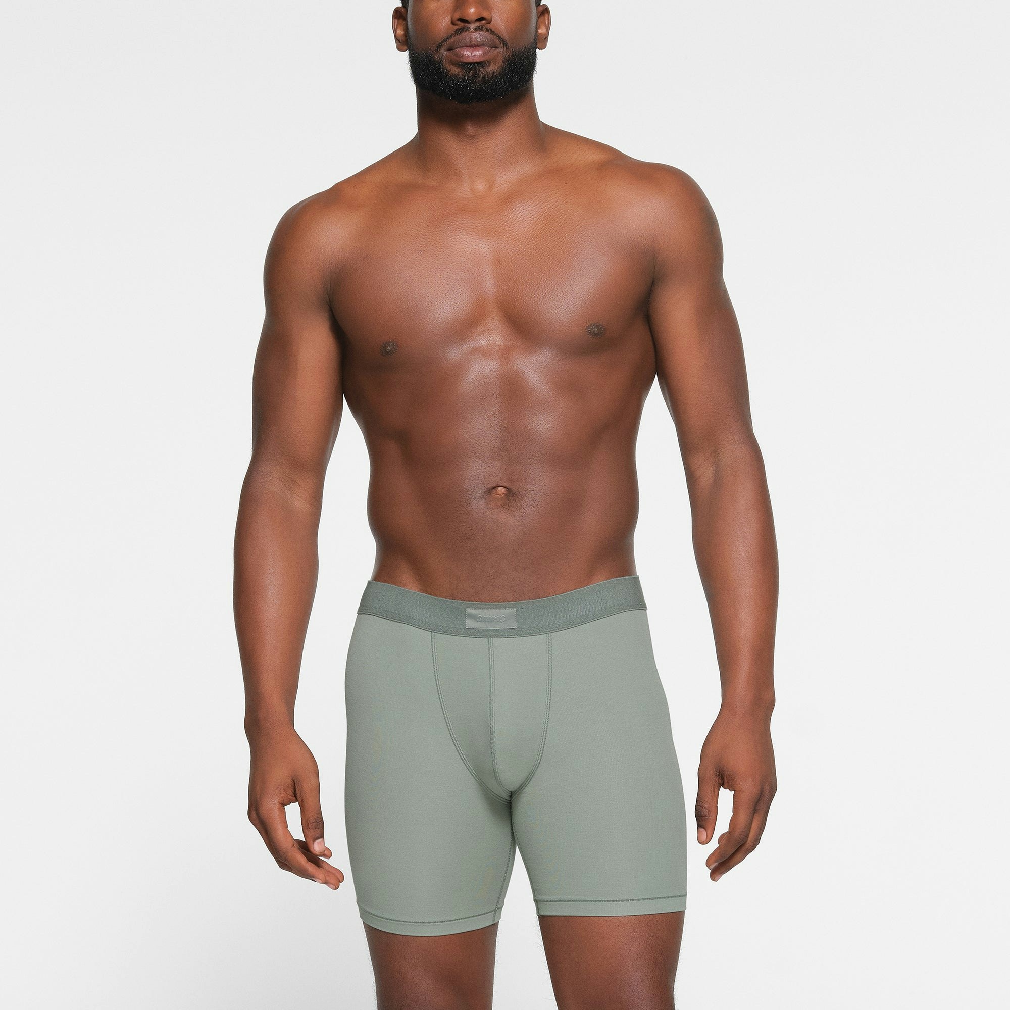 SKIMS COTTON MENS 5" BOXER BRIEF 3-PACK WORN BY A MODEL IN FRONT VIEW