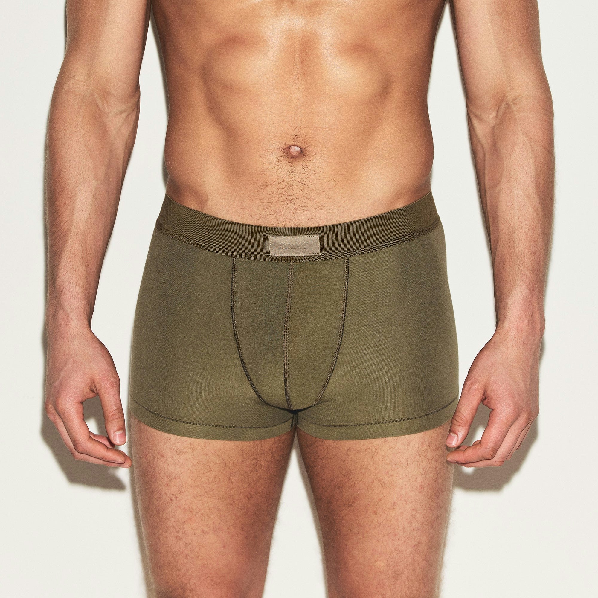 SKIMS COTTON MENS TRUNK | ARMY ON A MODEL FRONT VIEW | FOCUS: 0.0, 1.0, 0.9