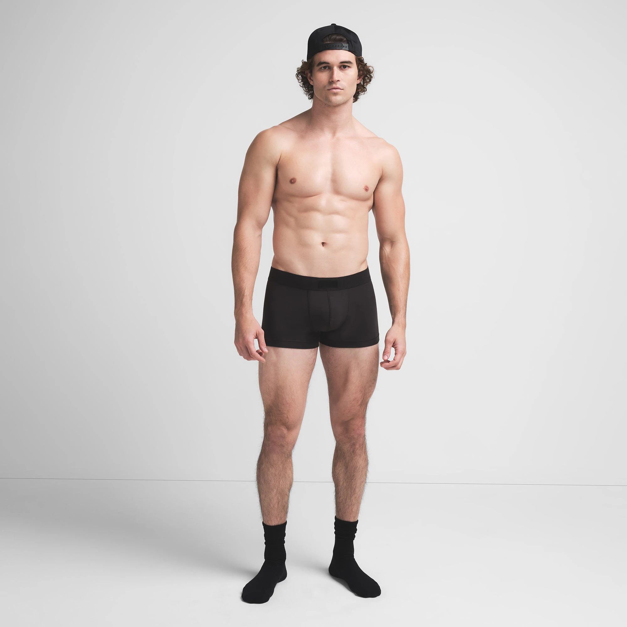SKIMS COTTON MENS TRUNK | ONYX ON A MODEL FRONT VIEW @ | FOCUS: 0.9, 0.1, 0.7