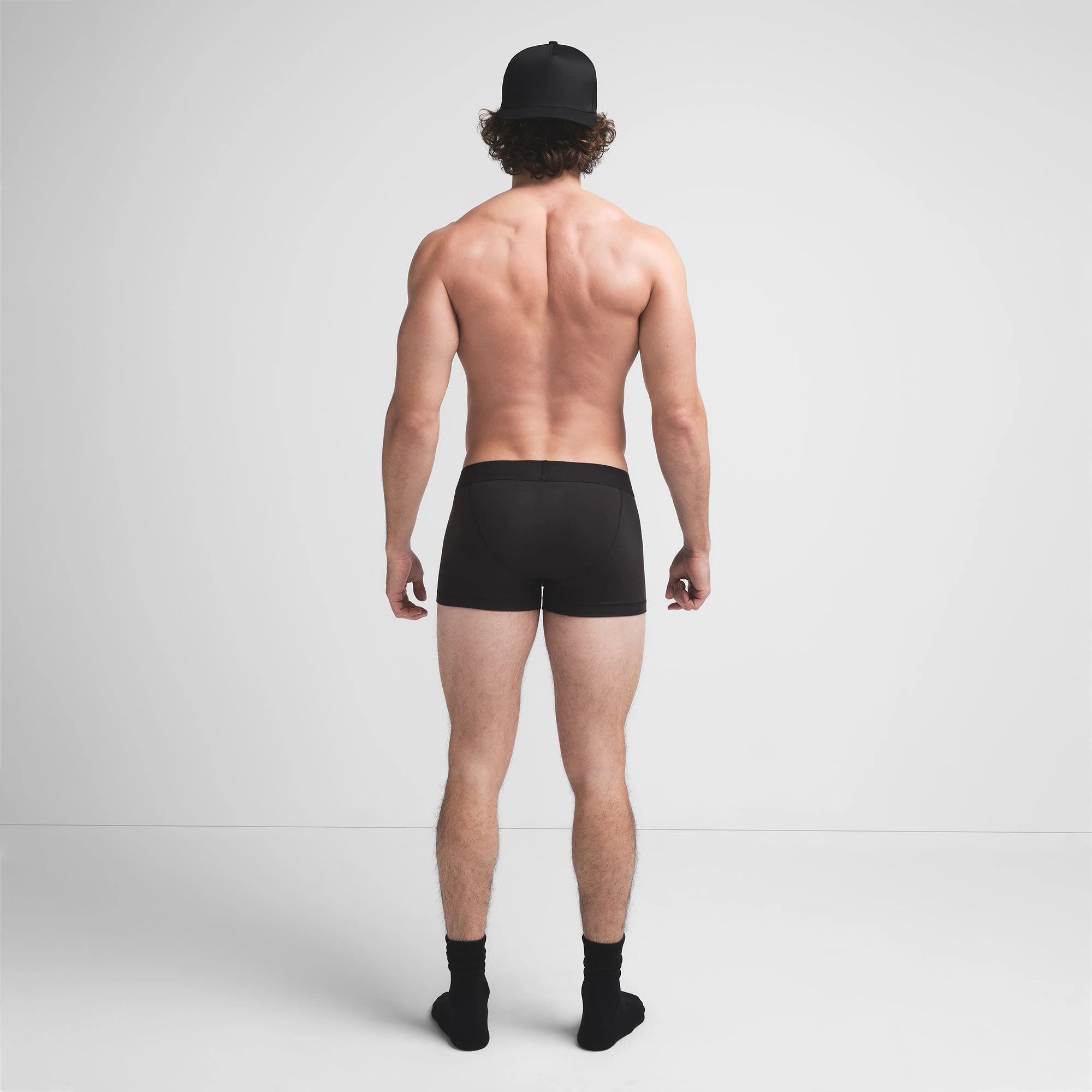 SKIMS COTTON MENS TRUNK | ONYX ON A MODEL BACK VIEW @ | FOCUS: 0.9, 0.1, 0.7