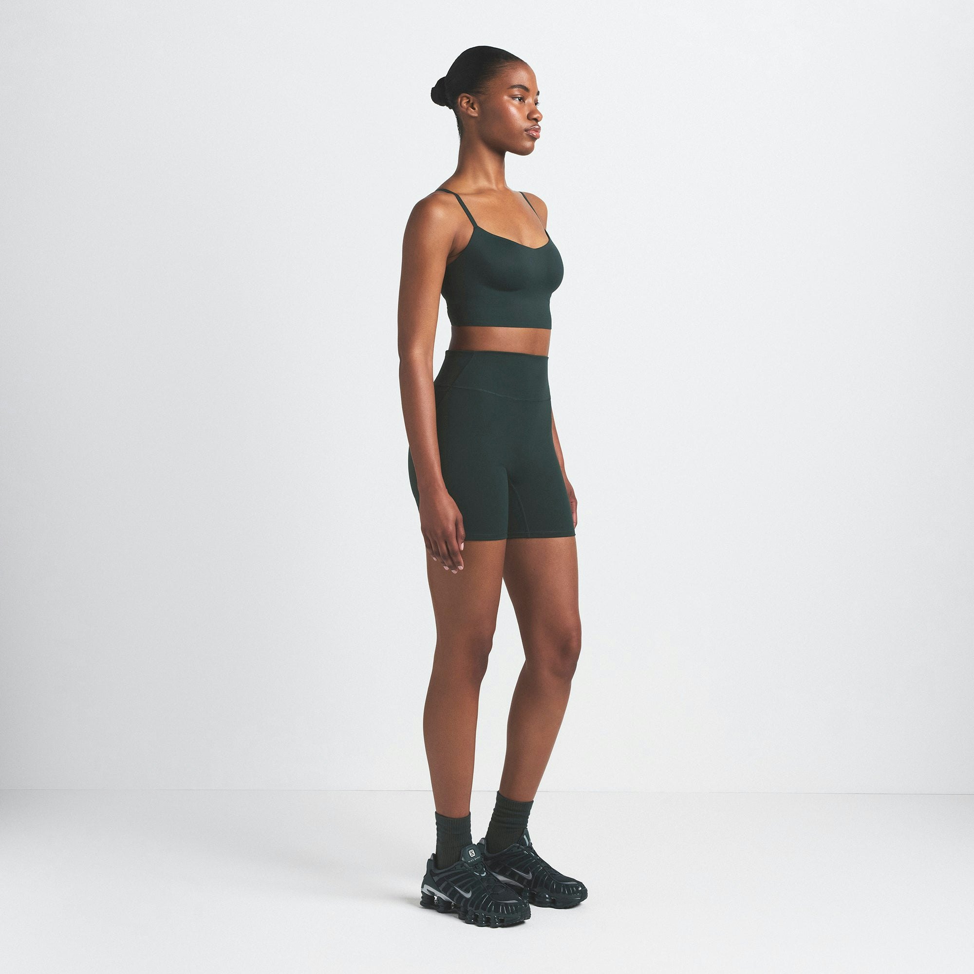 NikeSKIMS MATTE 5" BIKER SHORT | DARK TEAL ON A MODEL SIDE VIEW @ | FOCUS: 0.0, 1.0, 0.9