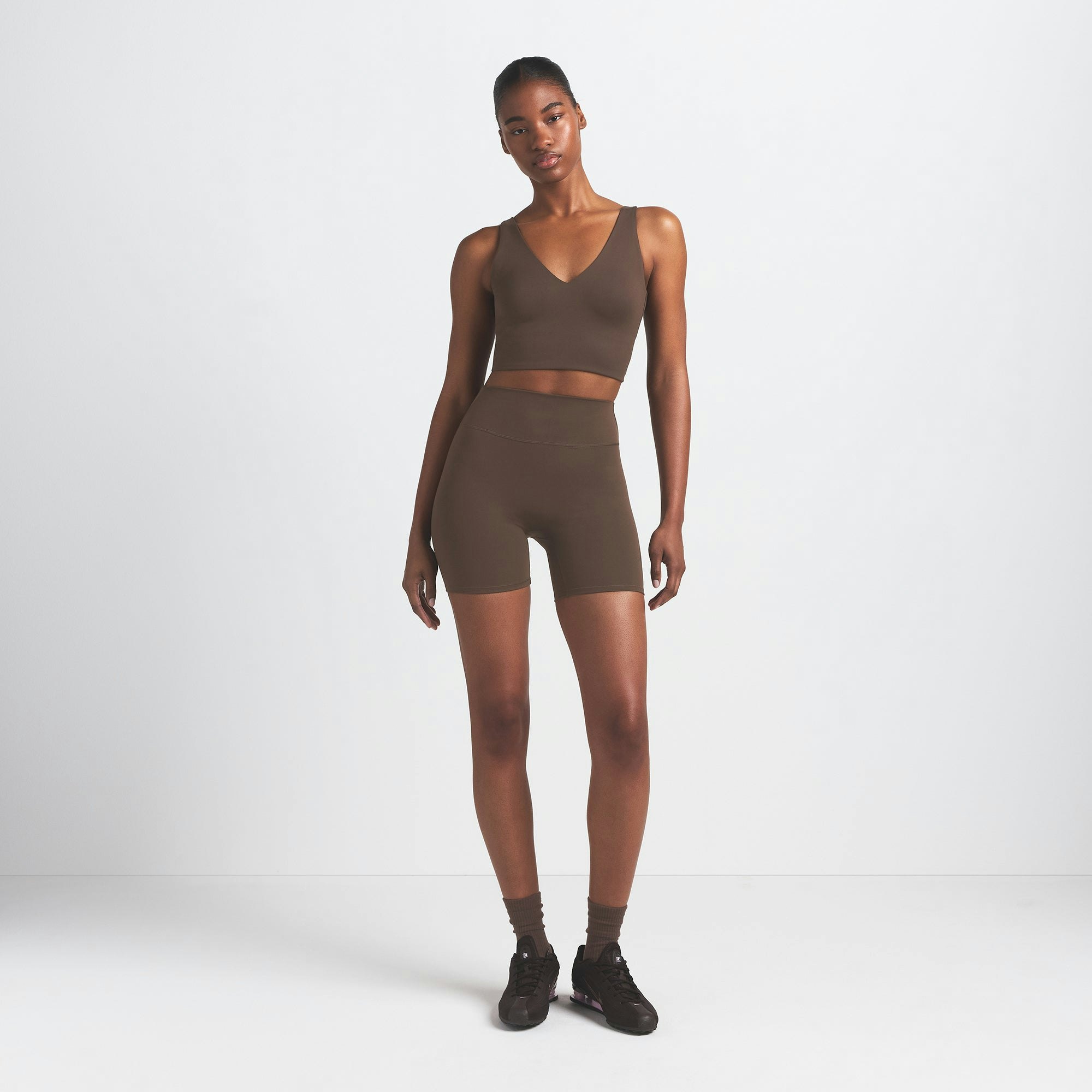 NikeSKIMS MATTE 5" BIKER SHORT | DARK SEPIA ON A MODEL FRONT VIEW @ | FOCUS: 0.9, 0.1, 0.7