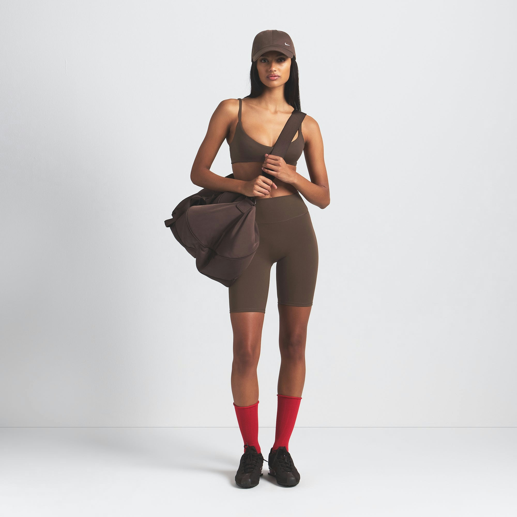 NikeSKIMS MATTE 7" BIKER SHORT | DARK SEPIA ON A MODEL FRONT VIEW @ | FOCUS: 0.9, 0.1, 0.7