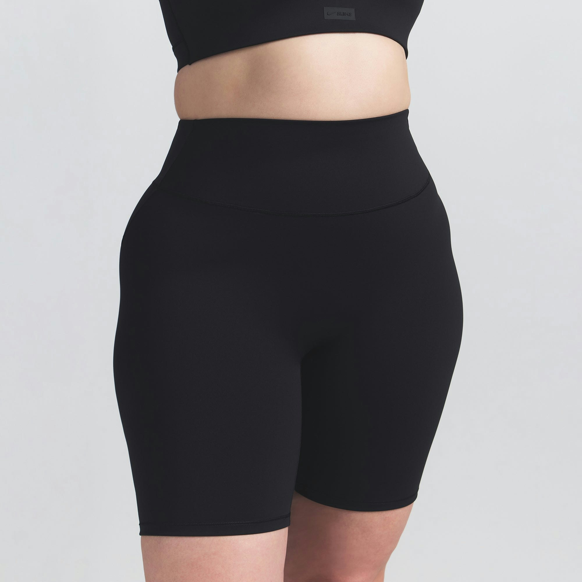 NikeSKIMS MATTE 7" BIKER SHORT | OBSIDIAN ON A MODEL FRONT VIEW