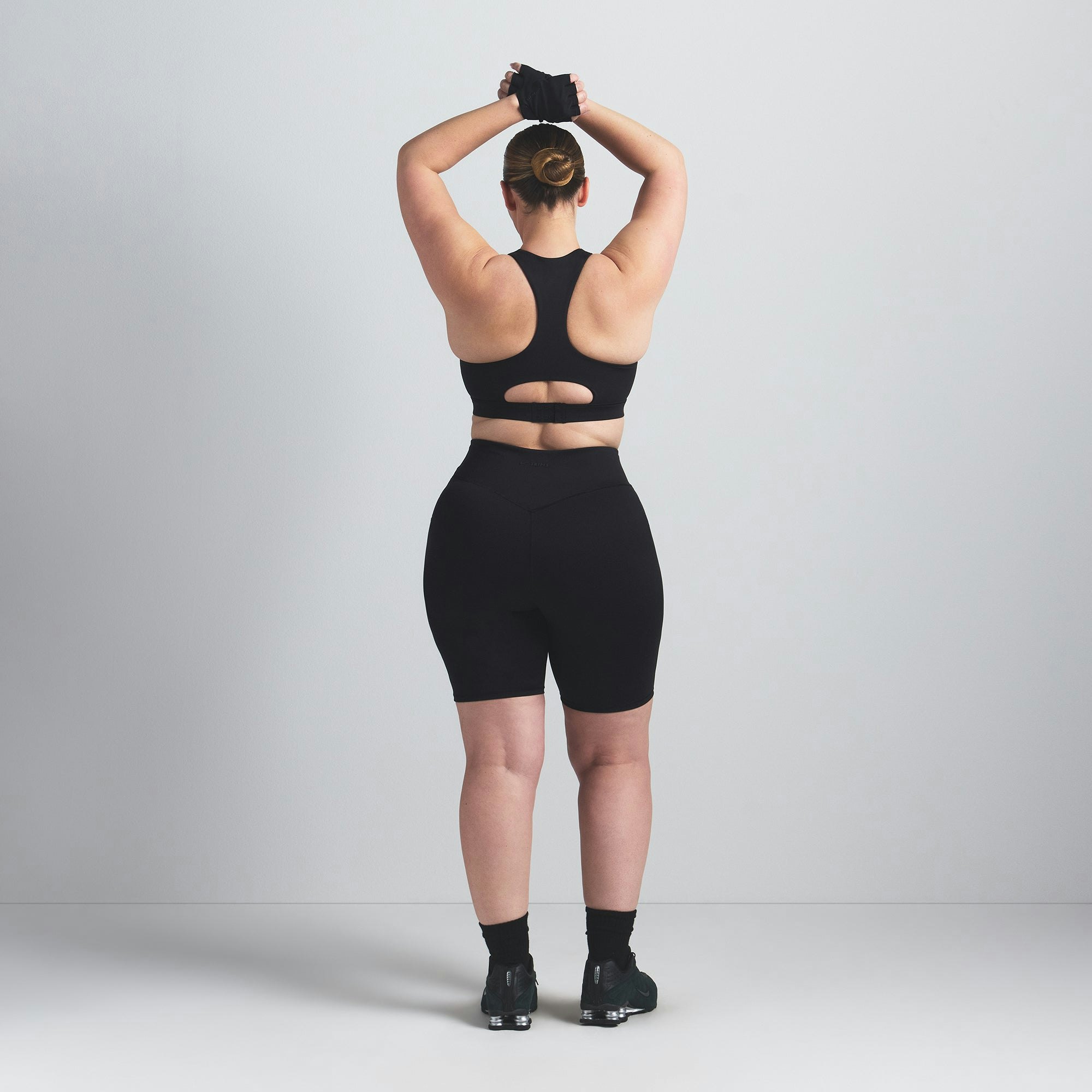 NikeSKIMS MATTE 7" BIKER SHORT | OBSIDIAN ON A MODEL BACK VIEW