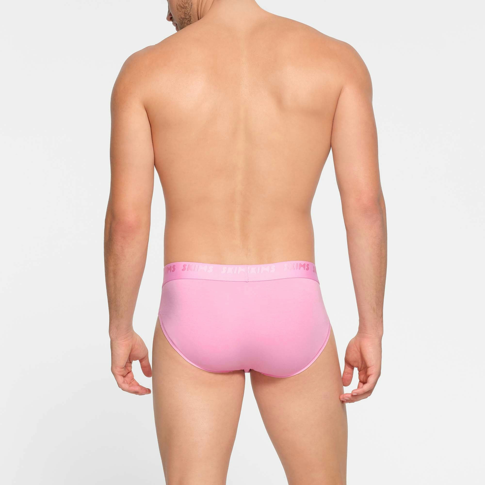 SKIMS STRETCH MENS BRIEF | BUBBLE GUM ON A MODEL BACK VIEW