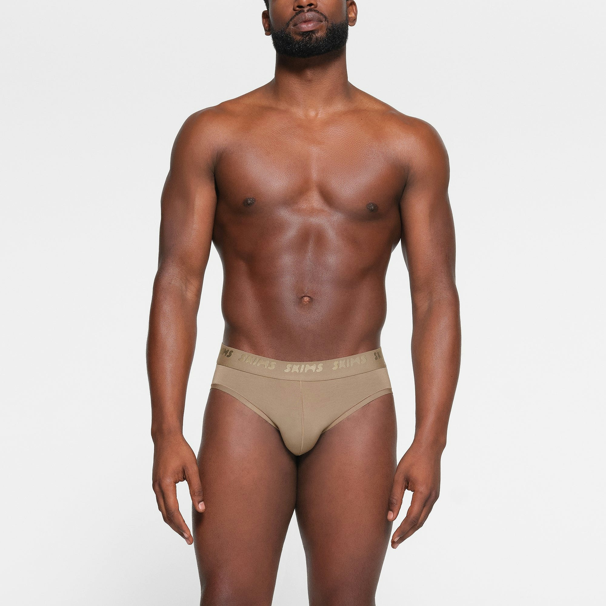 SKIMS STRETCH MENS BRIEF 3-PACK WORN BY A MODEL IN FRONT VIEW