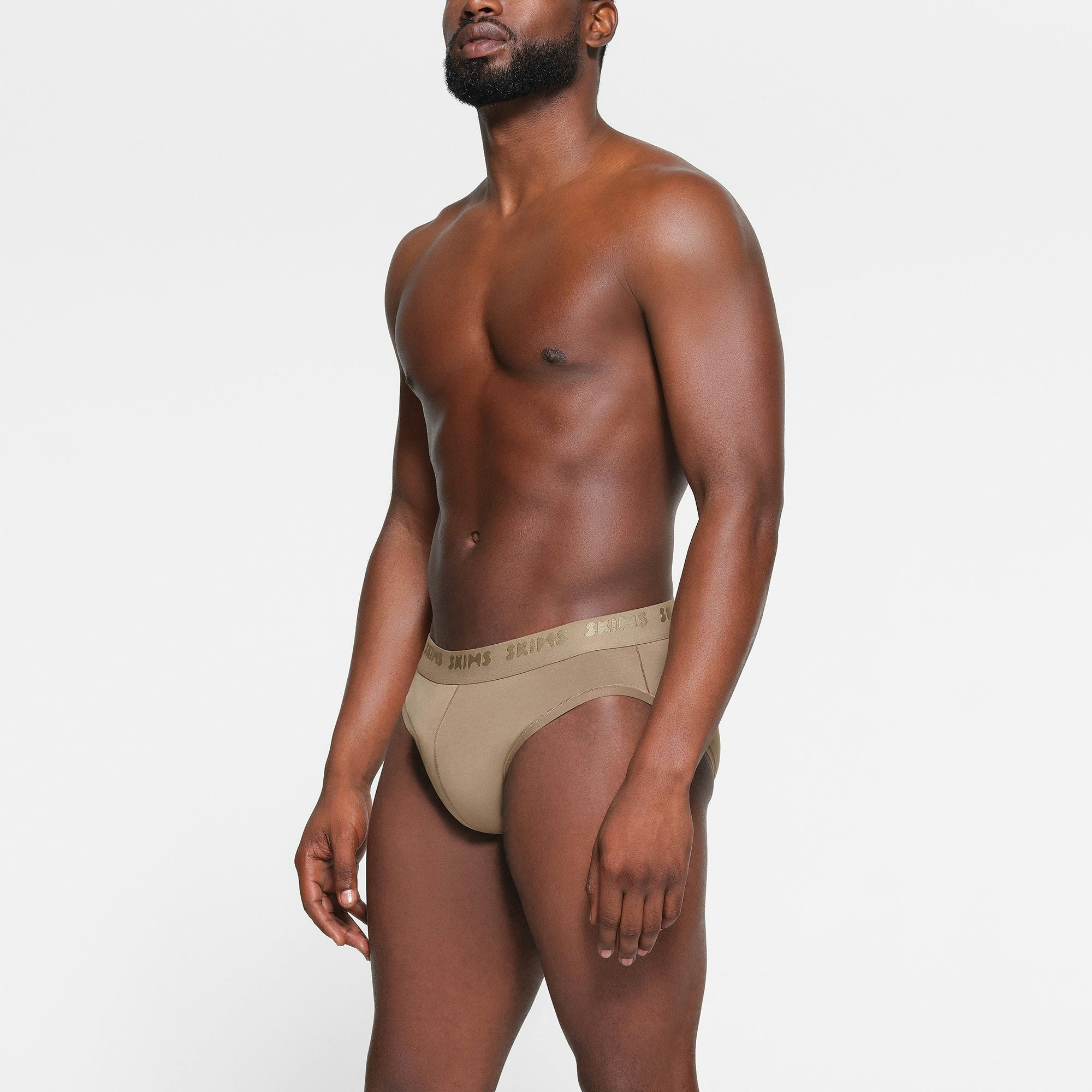 SKIMS STRETCH MENS BRIEF WORN BY A MODEL IN SIDE VIEW