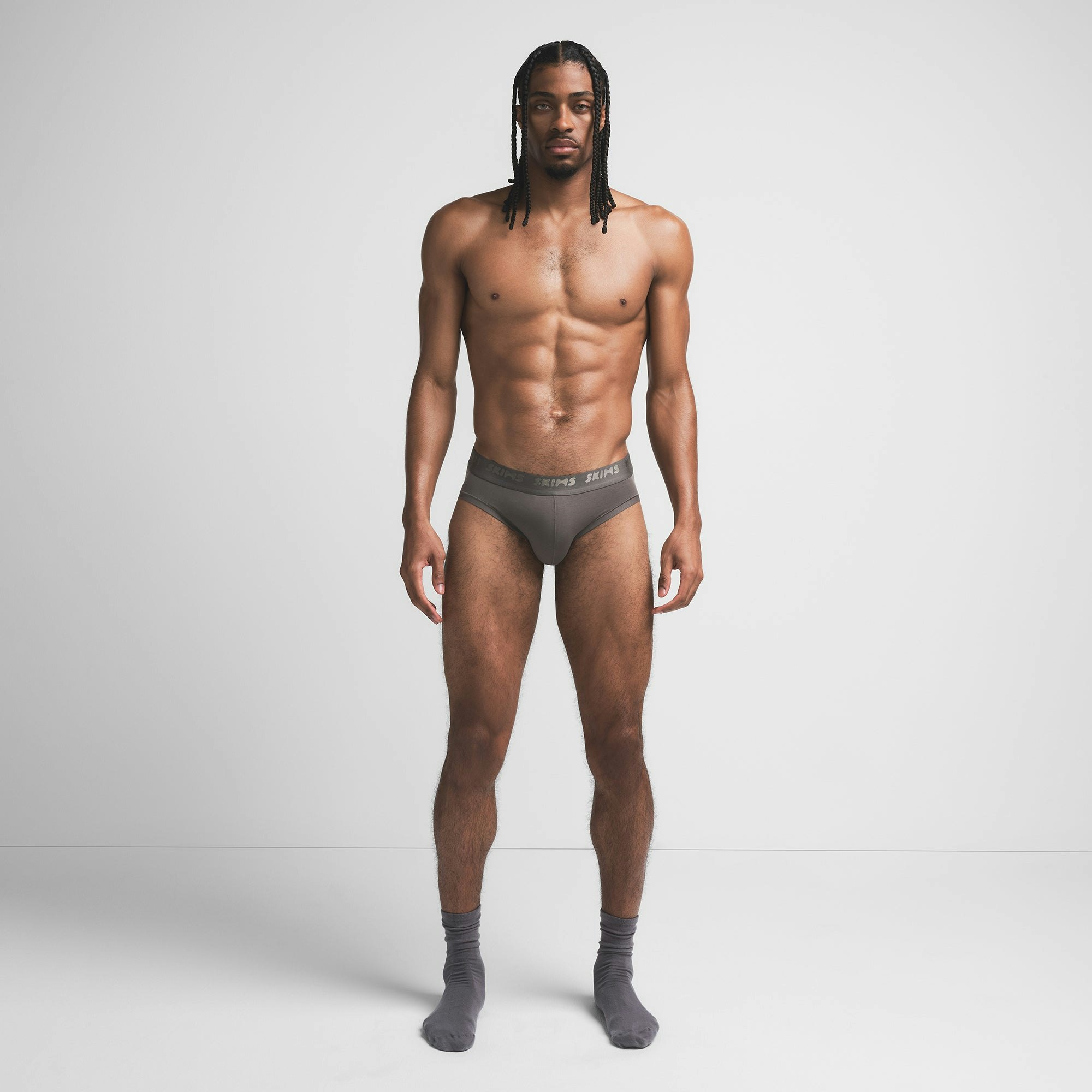 SKIMS STRETCH MENS BRIEF | GUNMETAL ON A MODEL FRONT VIEW @ | FOCUS: 0.9, 0.1, 0.7