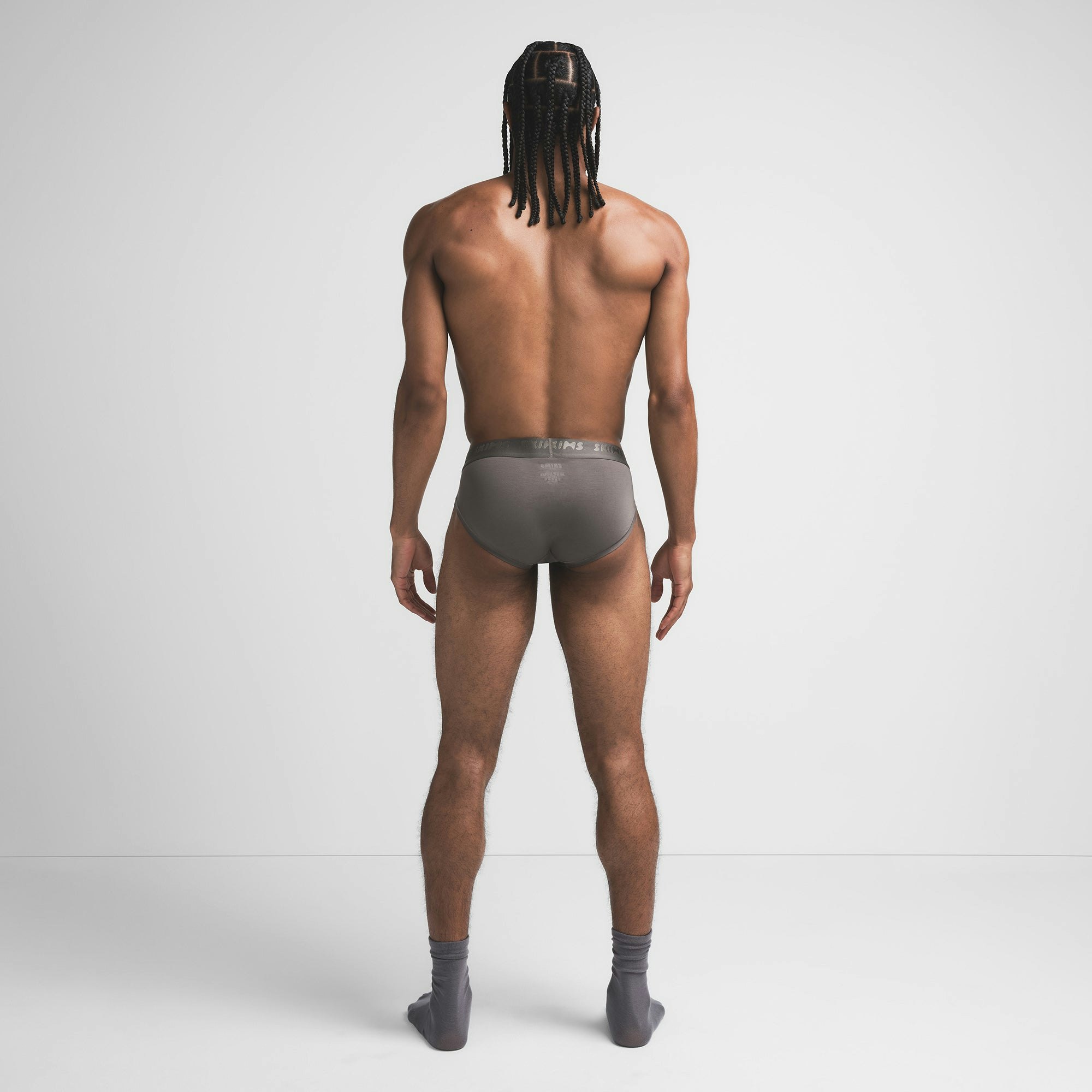 SKIMS STRETCH MENS BRIEF | GUNMETAL ON A MODEL BACK VIEW @ | FOCUS: 0.9, 0.1, 0.7