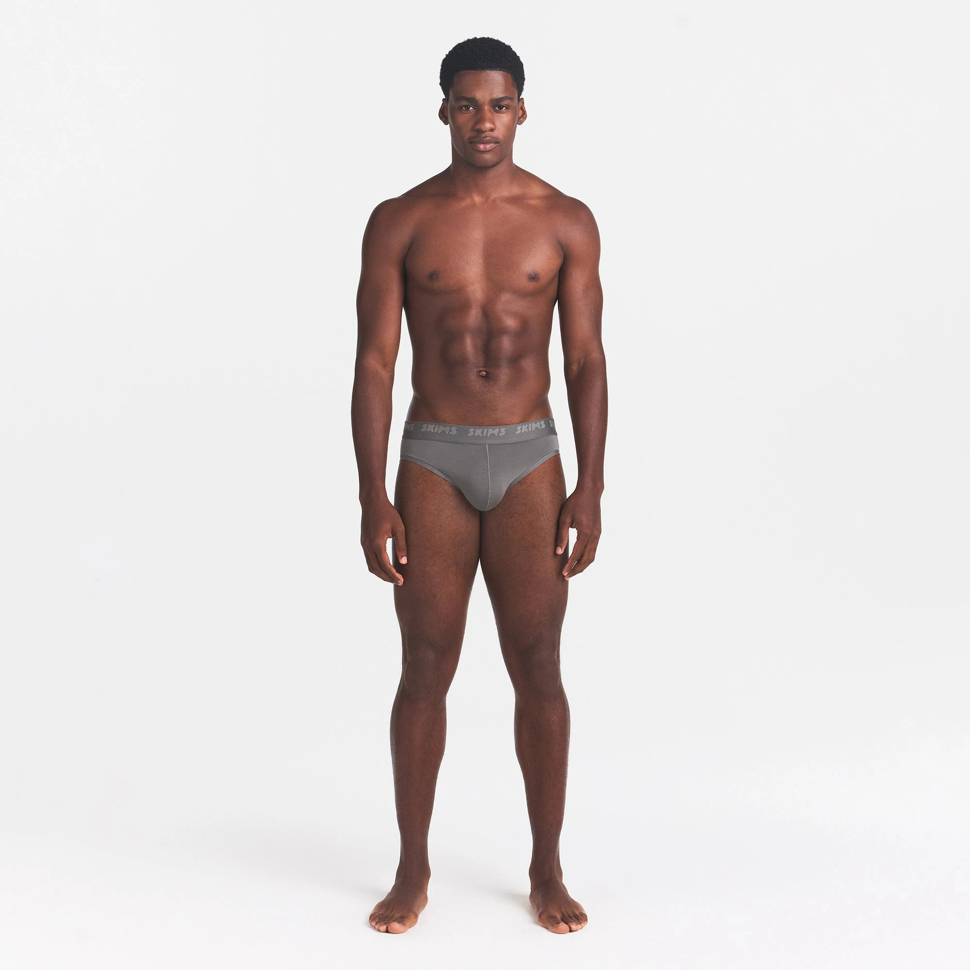 SKIMS STRETCH MENS BRIEF | GUNMETAL ON A MODEL FRONT VIEW @ | FOCUS: 0.0, 1.0, 0.9