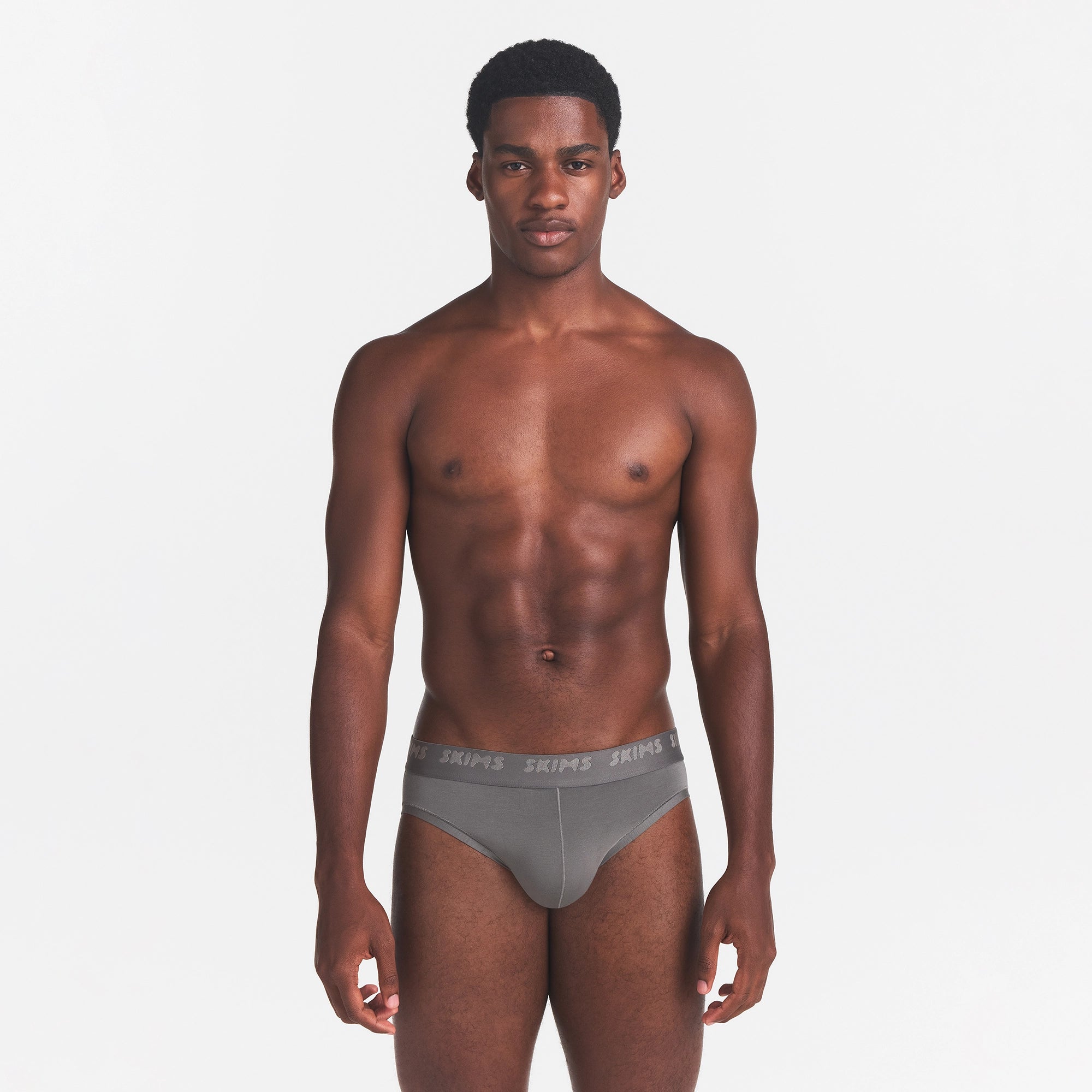 SKIMS STRETCH MENS BRIEF | GUNMETAL ON A MODEL FRONT VIEW