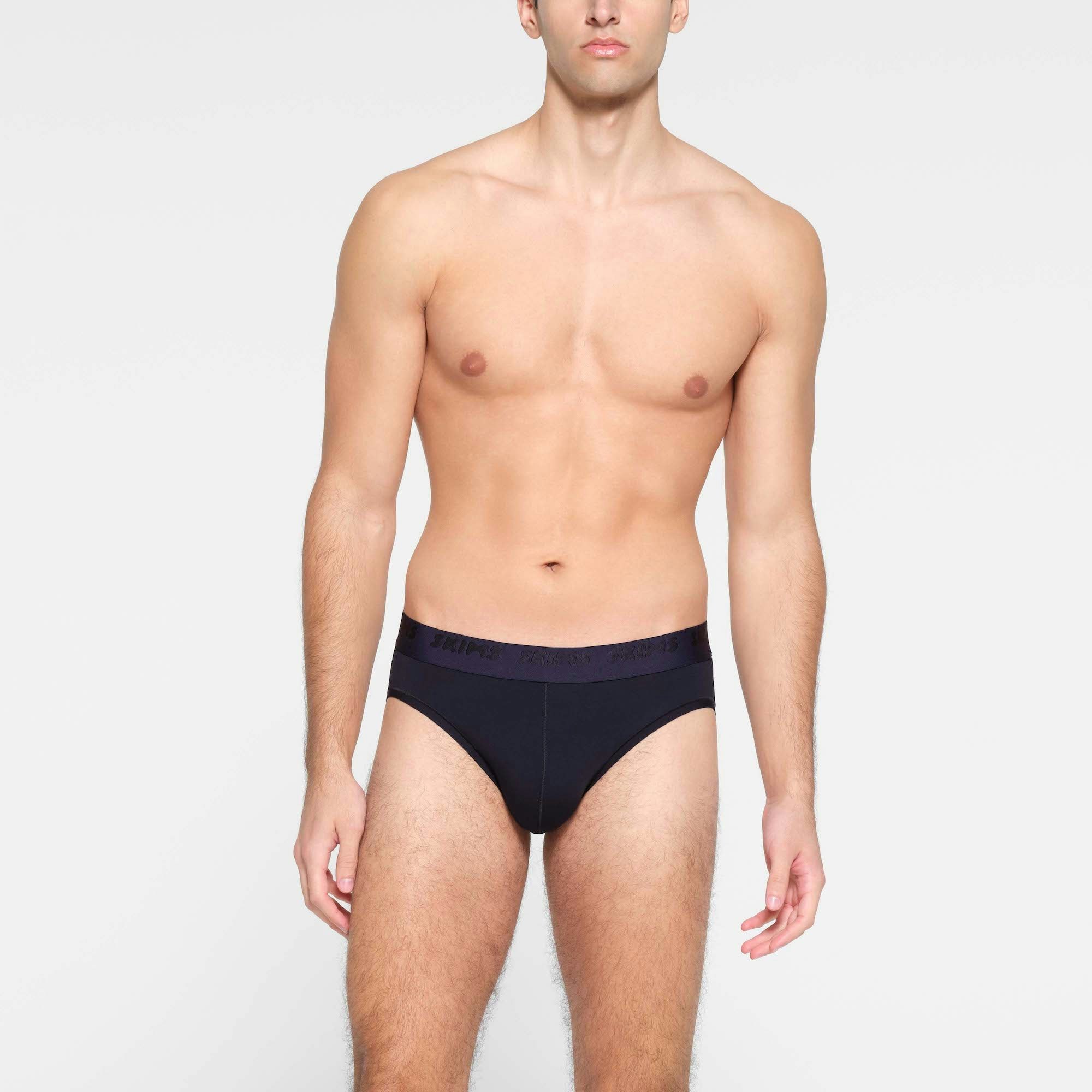 SKIMS STRETCH MENS BRIEF | MIDNIGHT BLUE ON A MODEL FRONT VIEW