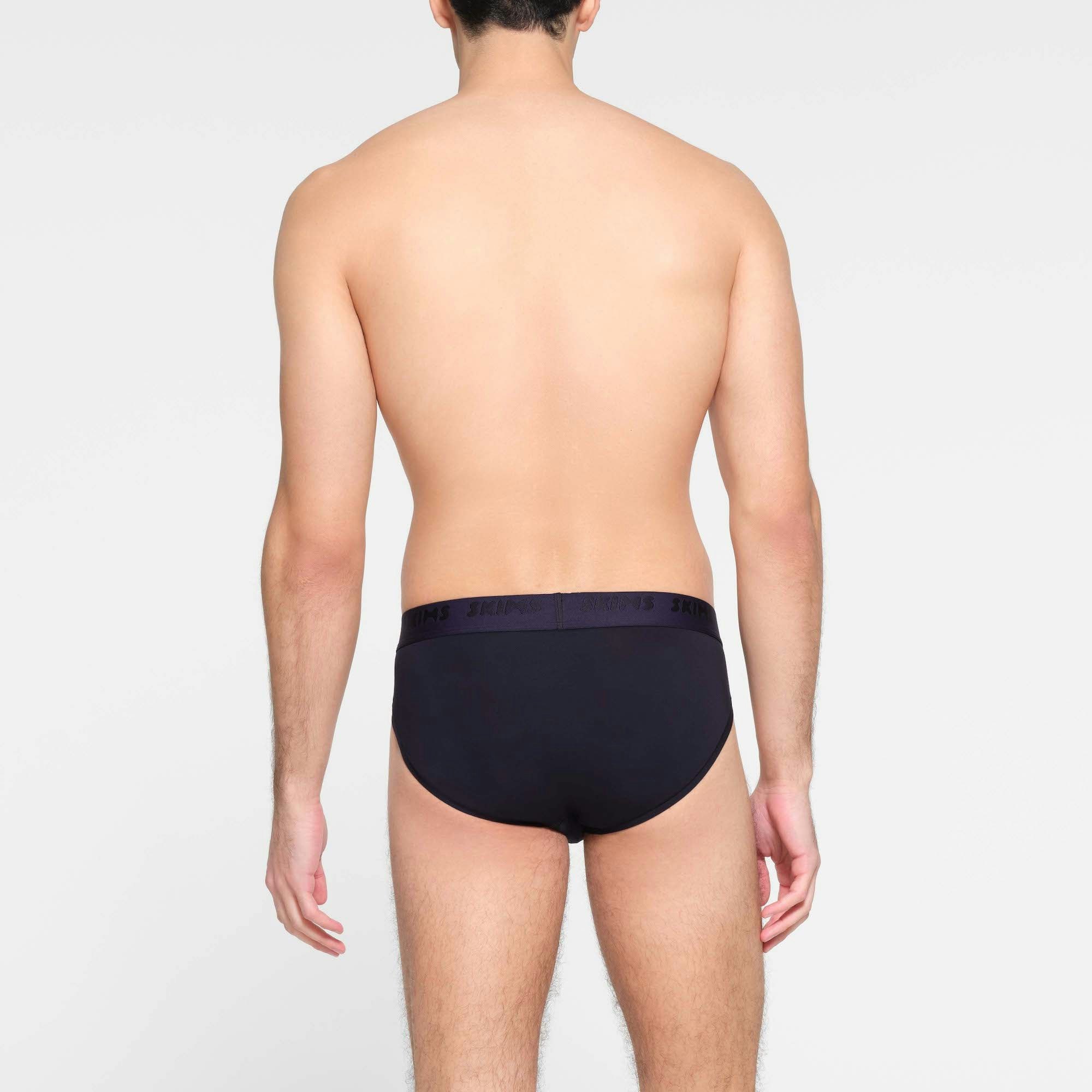 SKIMS STRETCH MENS BRIEF | MIDNIGHT BLUE ON A MODEL BACK VIEW