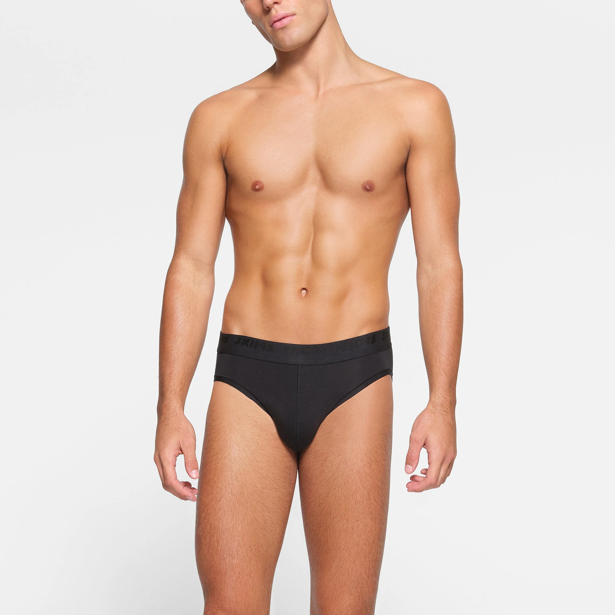 SKIMS STRETCH MENS BRIEF 3-PACK WORN BY A MODEL IN FRONT VIEW