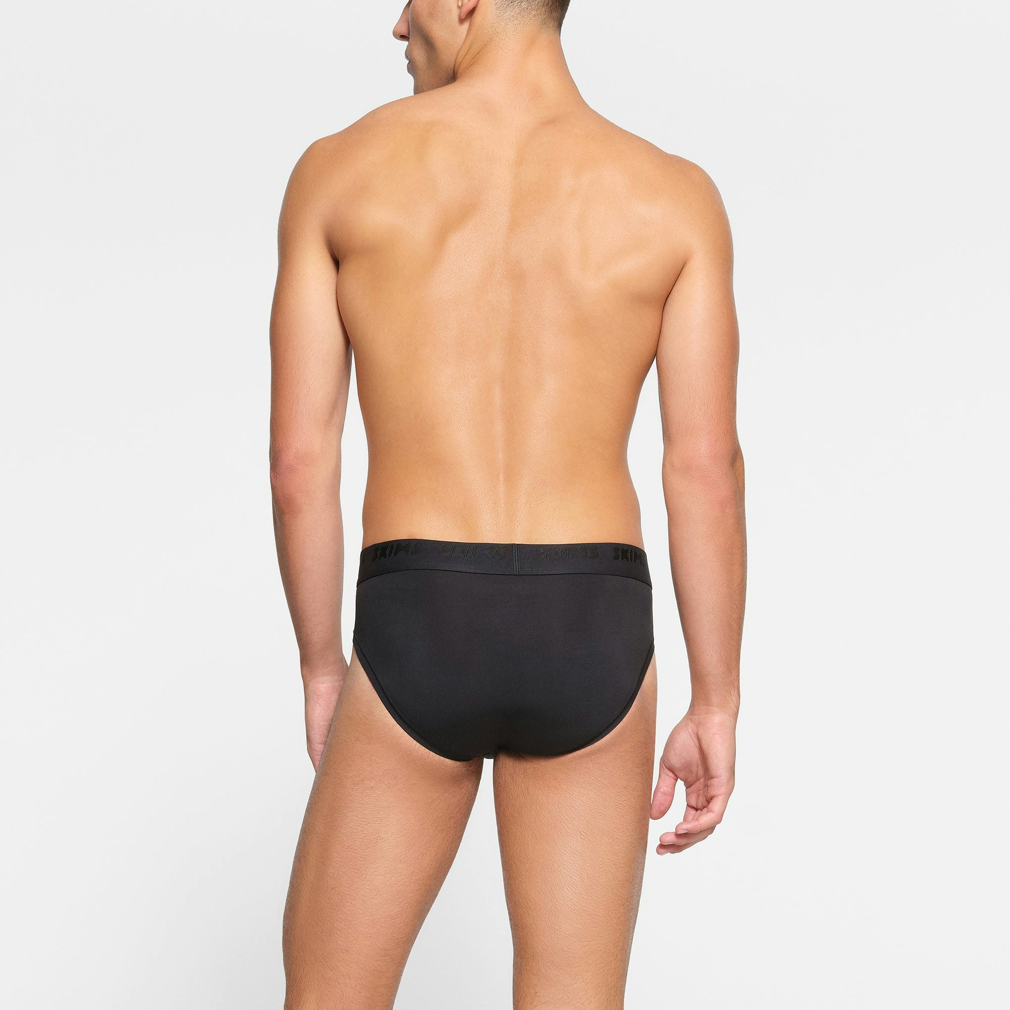 SKIMS STRETCH MENS BRIEF 3-PACK ON A MODEL BACK VIEW